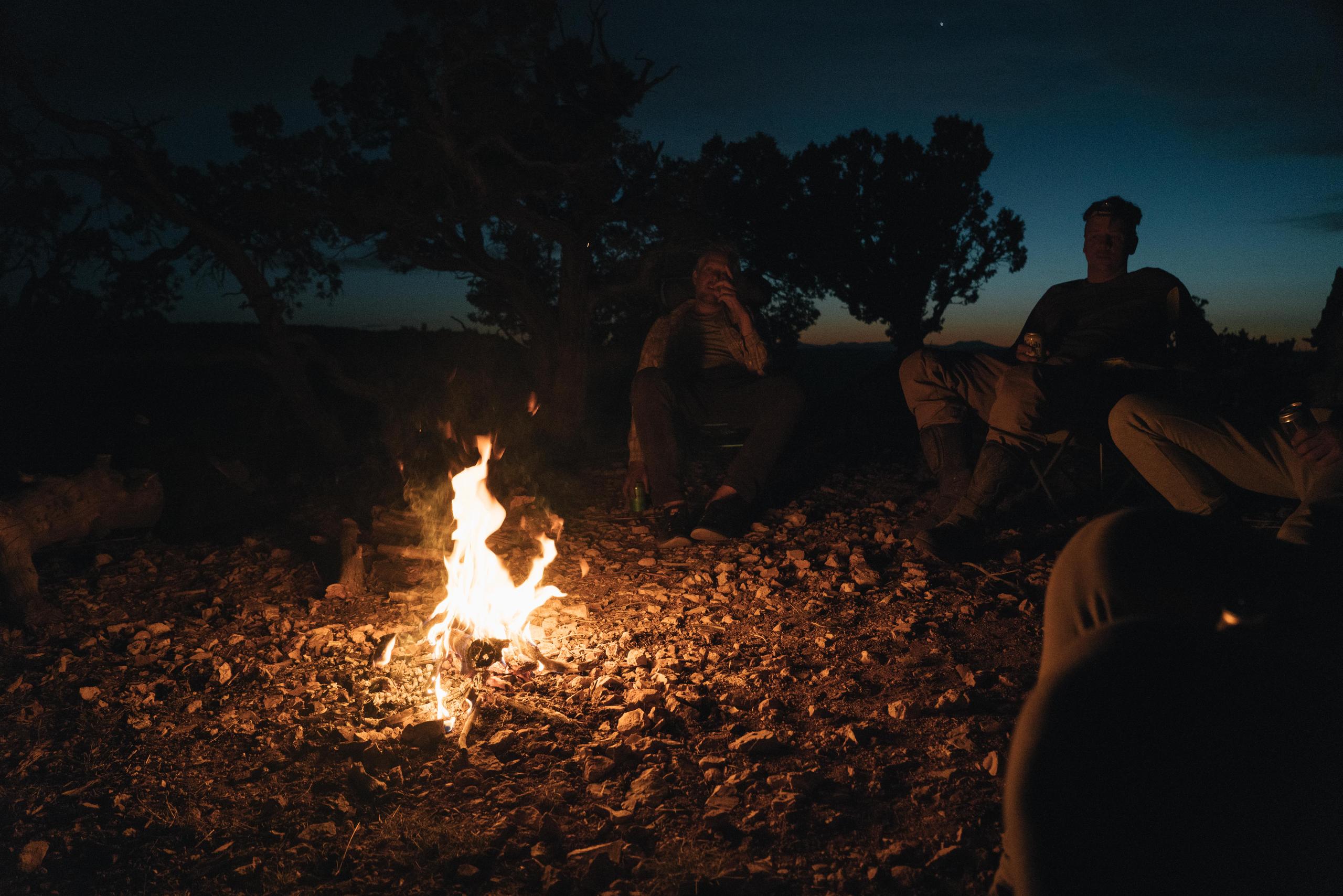 Group of men outside campfire in Canyonlands National Park.