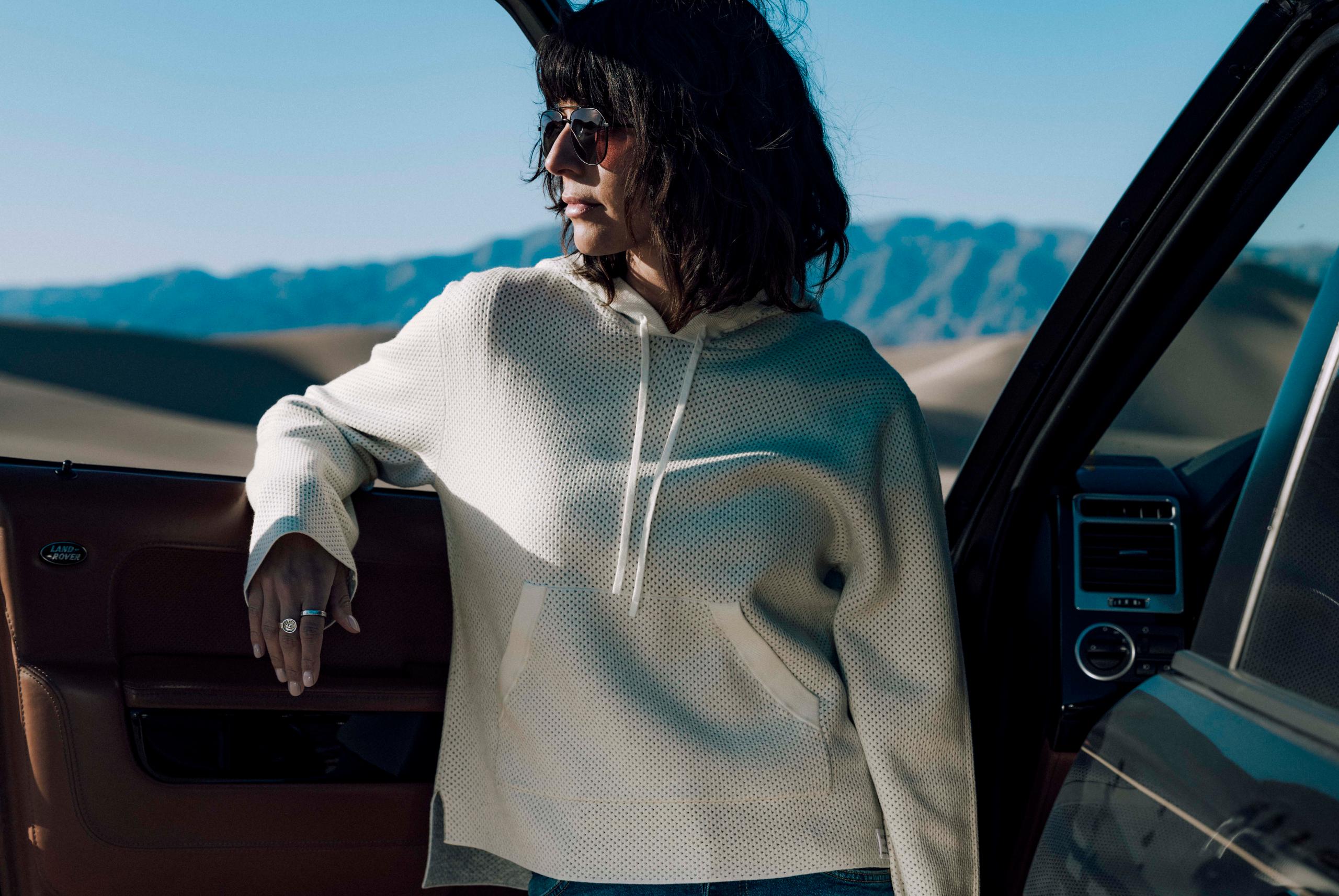 Woman in Bryce Sunglass leaning against a car door. 