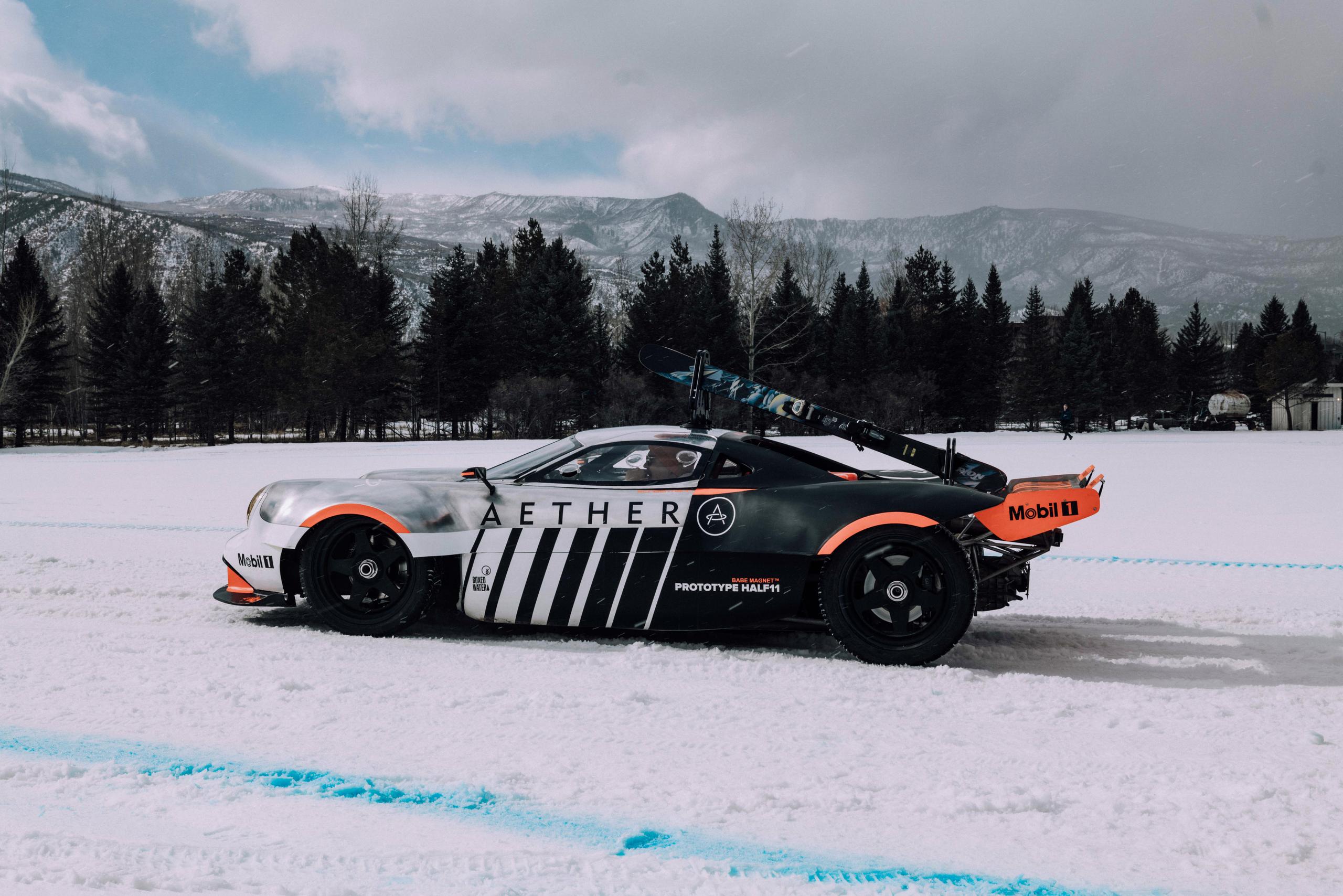 Profile view of Half11 prototype on ice race with the Rocky mountains in the background