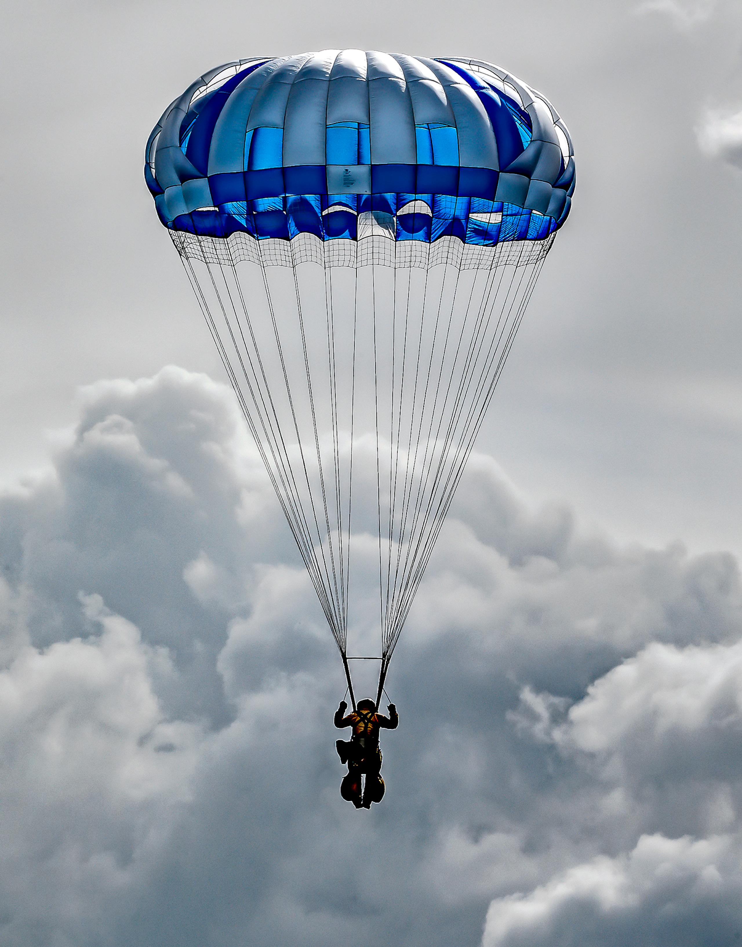 smokerjumper with parachute and clouds