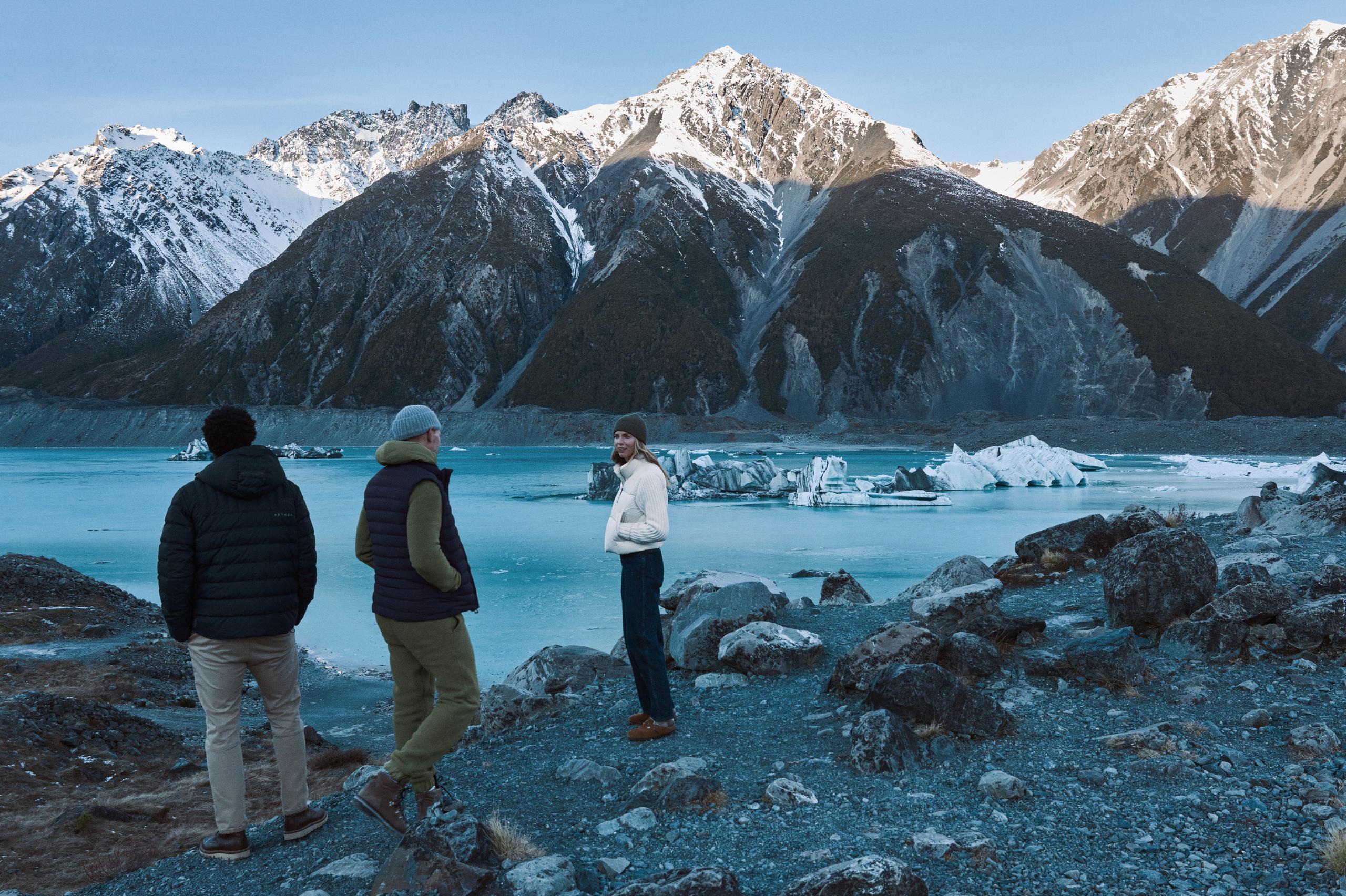 Group of friends exploring around a glacier lake in New Zealnd.