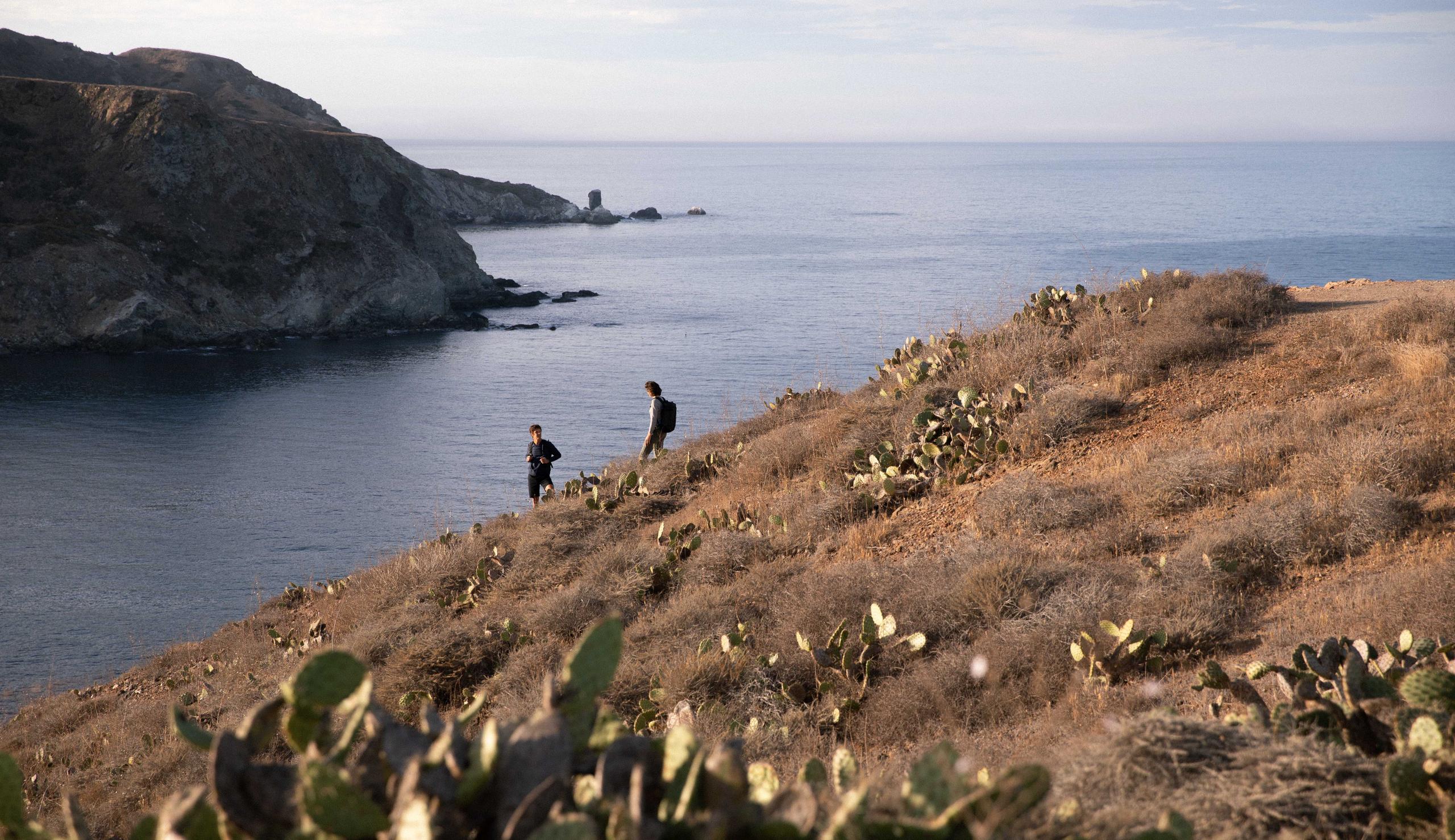 A couple hiking down hill on Catalina Island