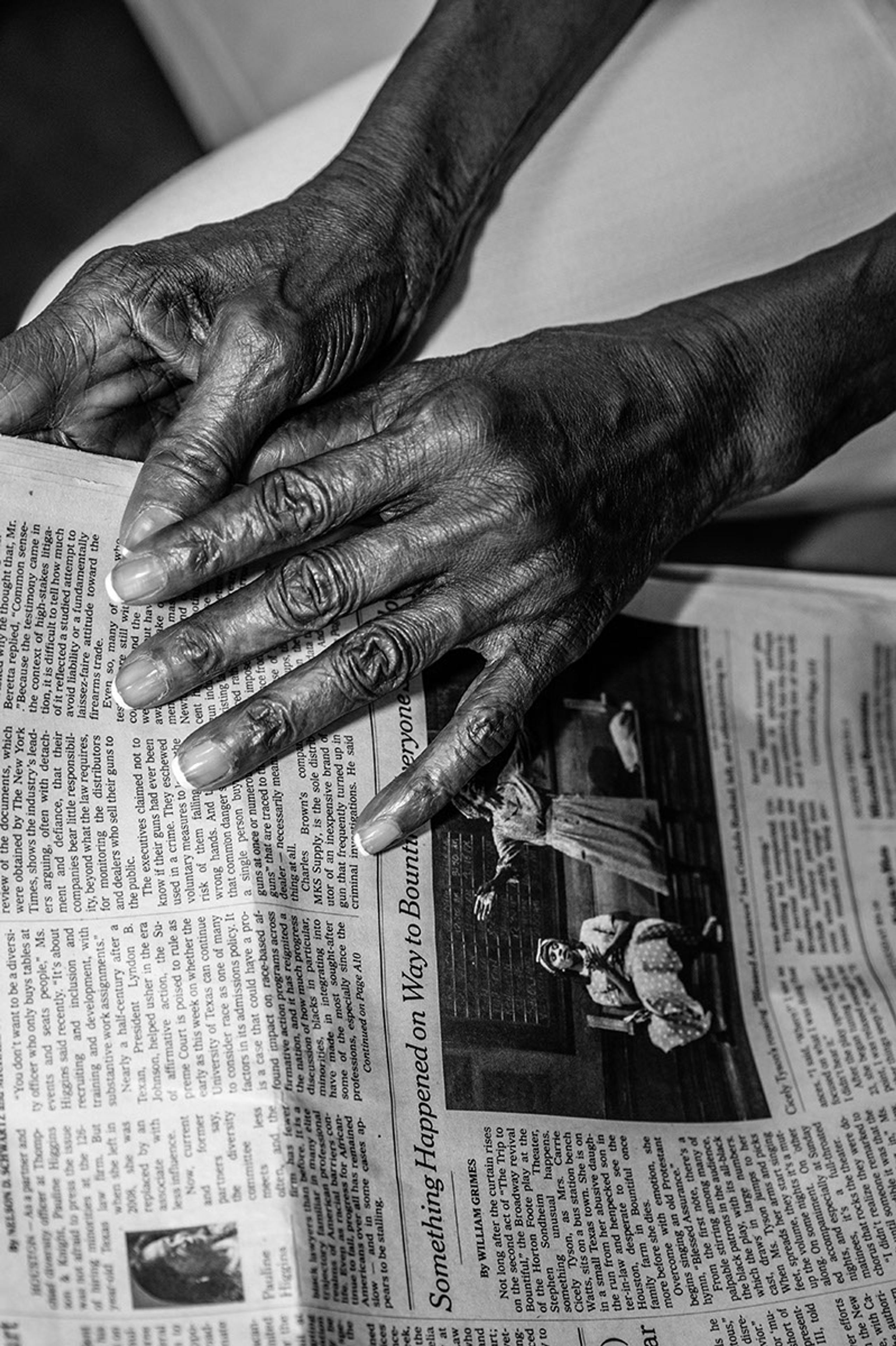 Hands of Cicely Tyson holding a newspaper