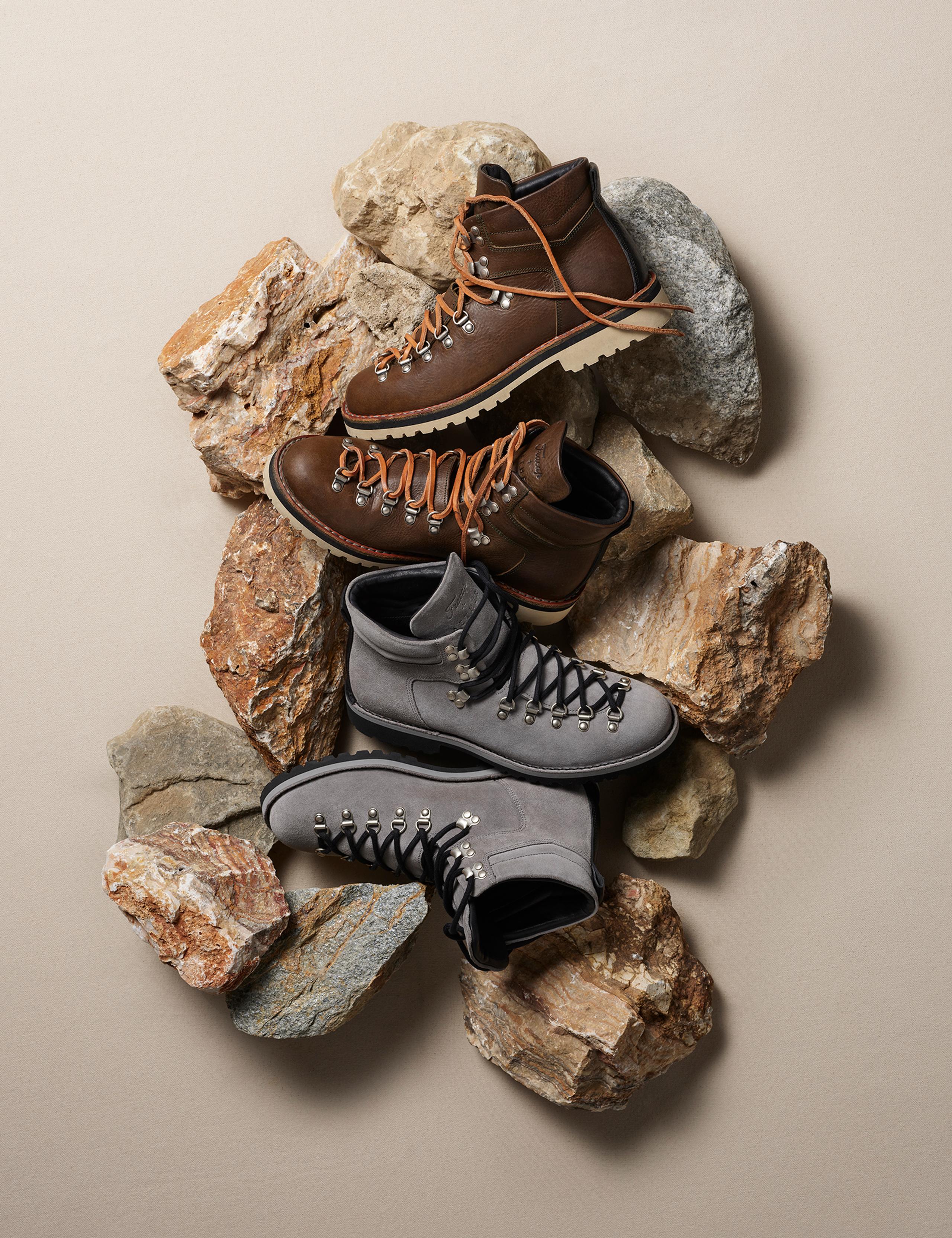 Men's Dolomite Boots arranged on top of collection of coastal sea rocks