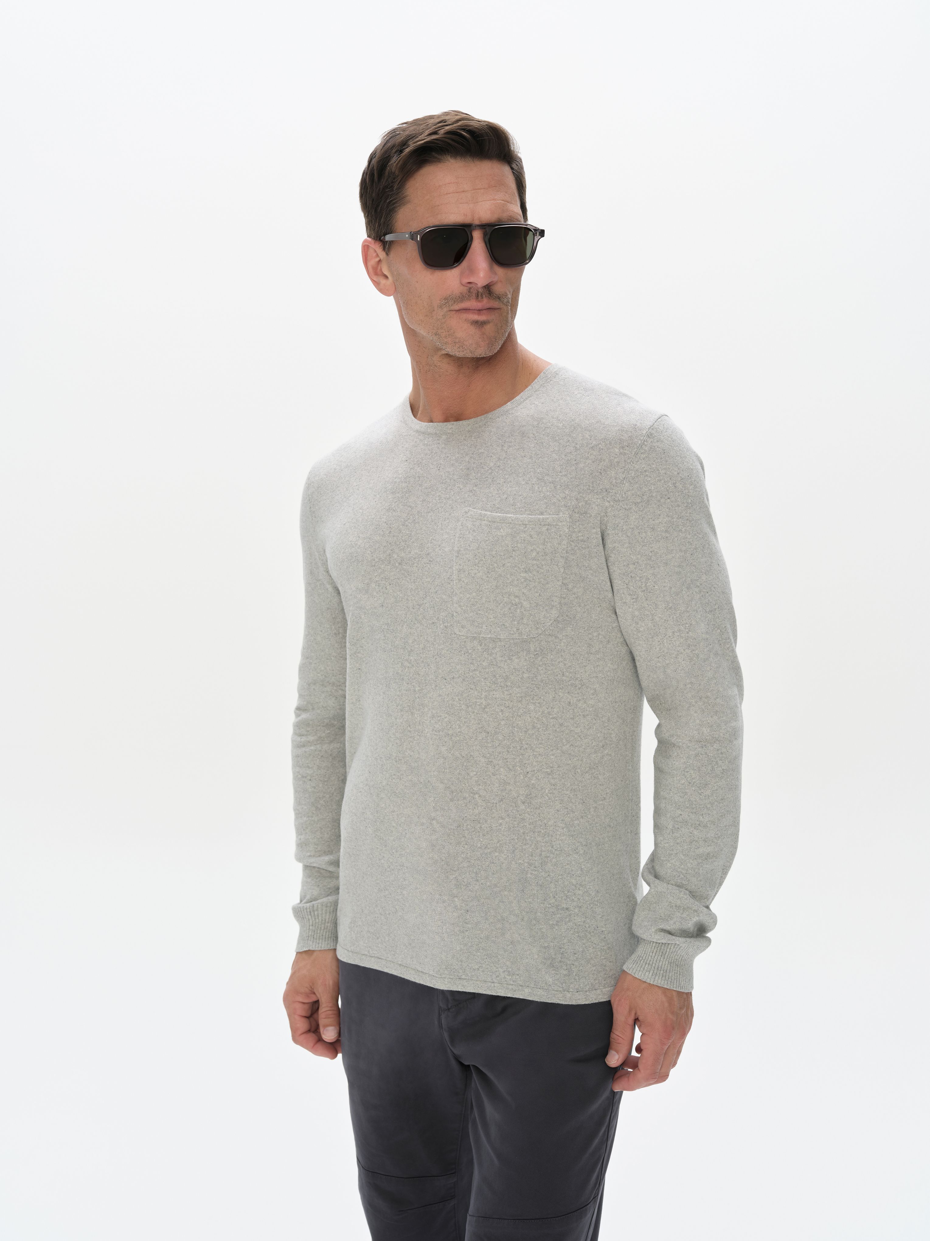 Man wearing the Aero Crewneck Sweater 2.0 in Grey