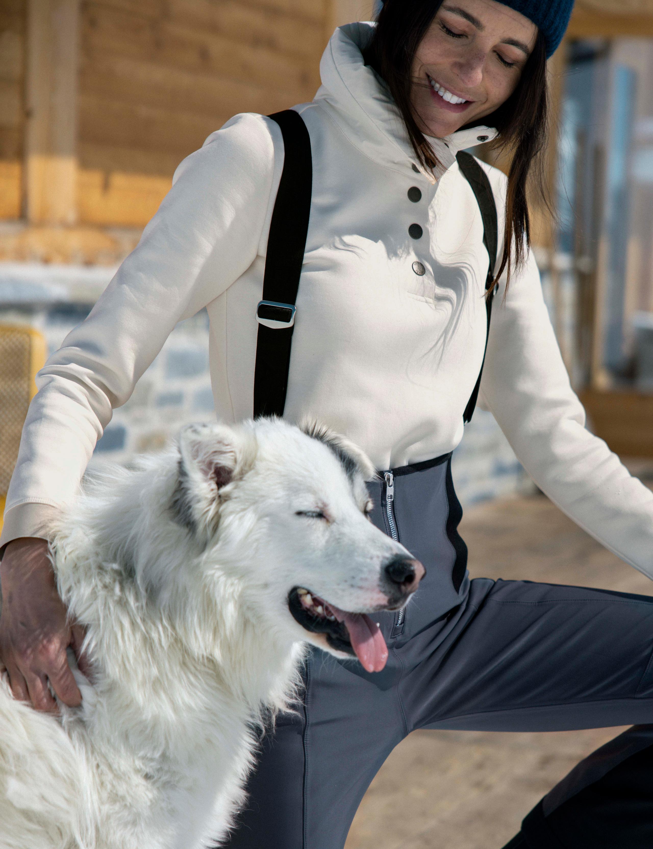A woman wearing Align Pullover with a dog.
