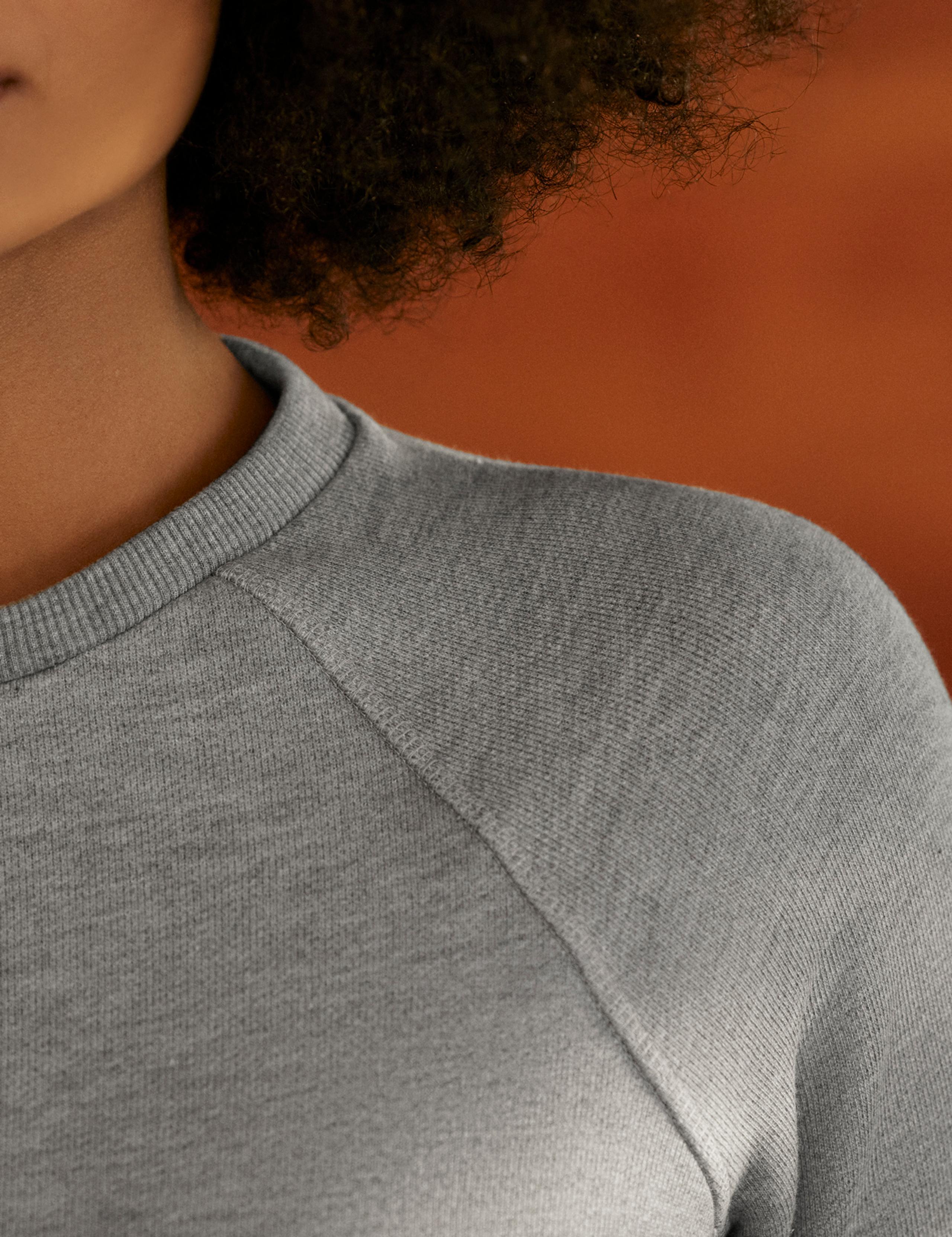 Closeup view of shoulder and neckline of woman wearing Foundation Raglan Sweatshirt