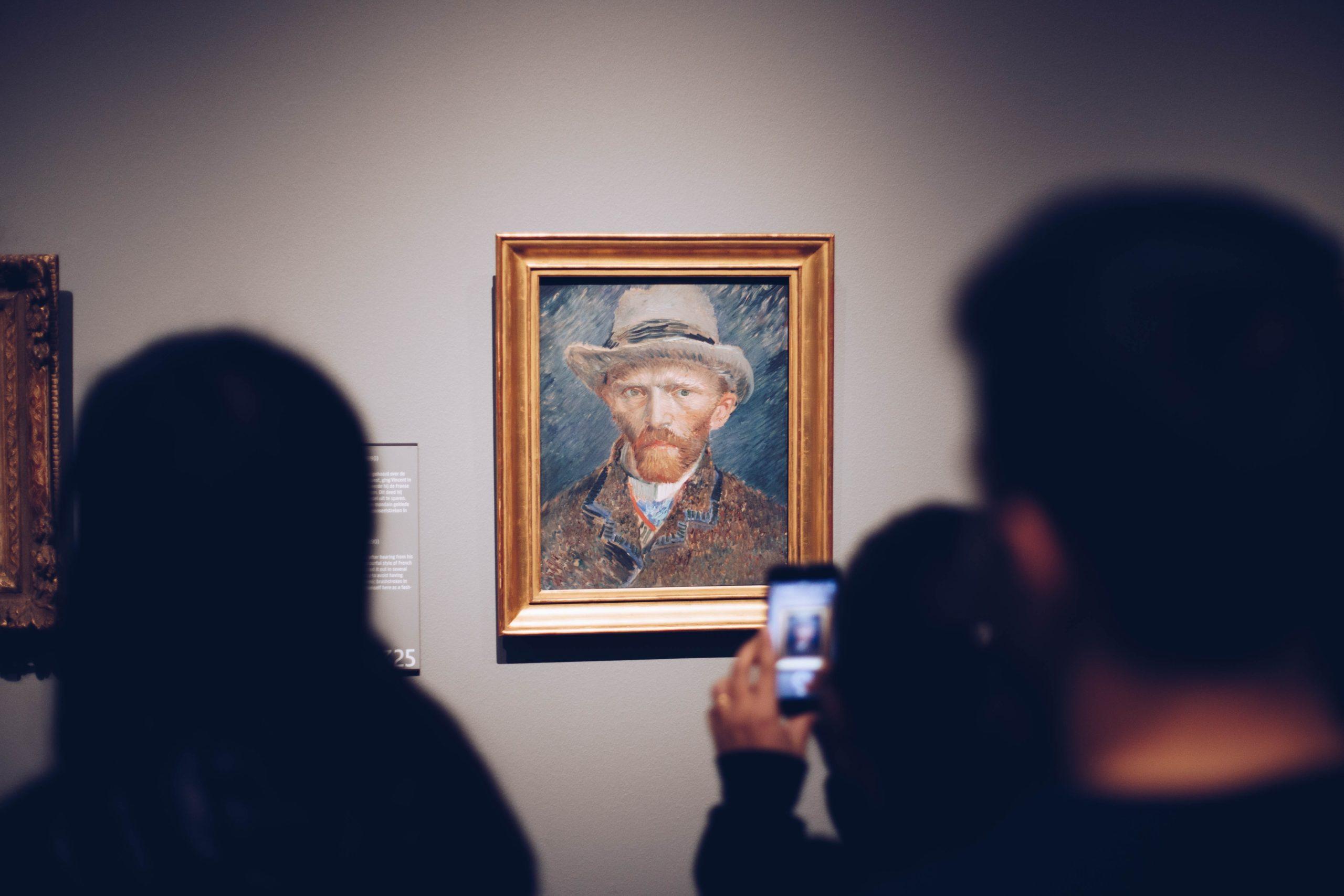 people looking at painting of Vincent van Gogh