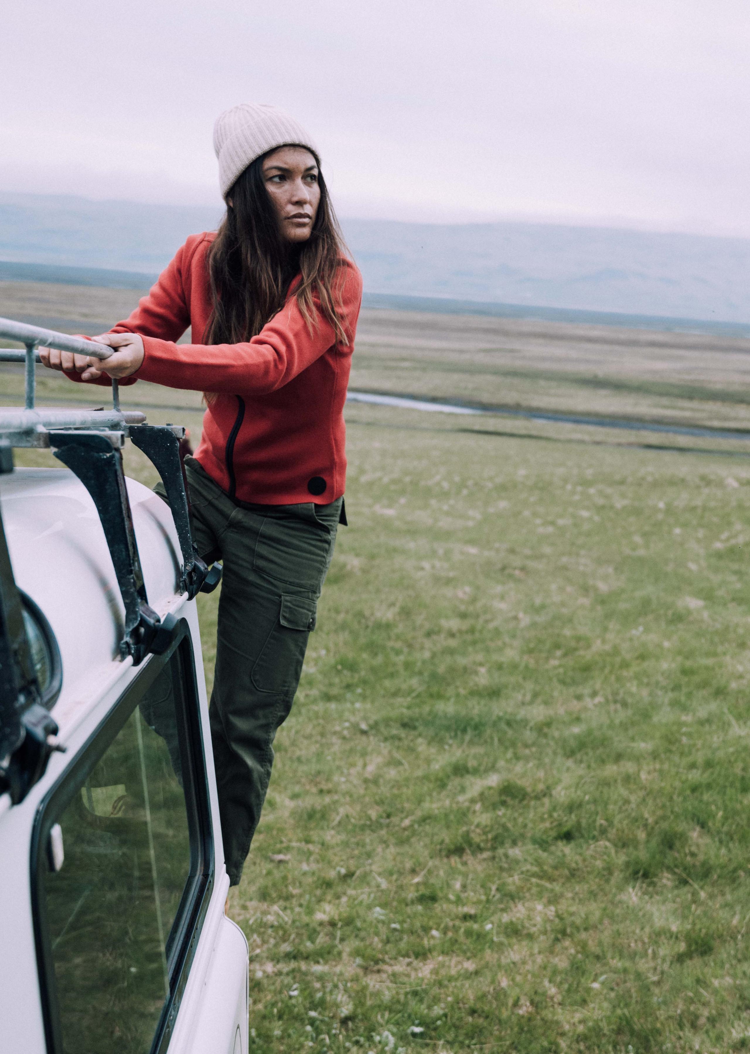 Woman wearing the racing red riley full-zip.