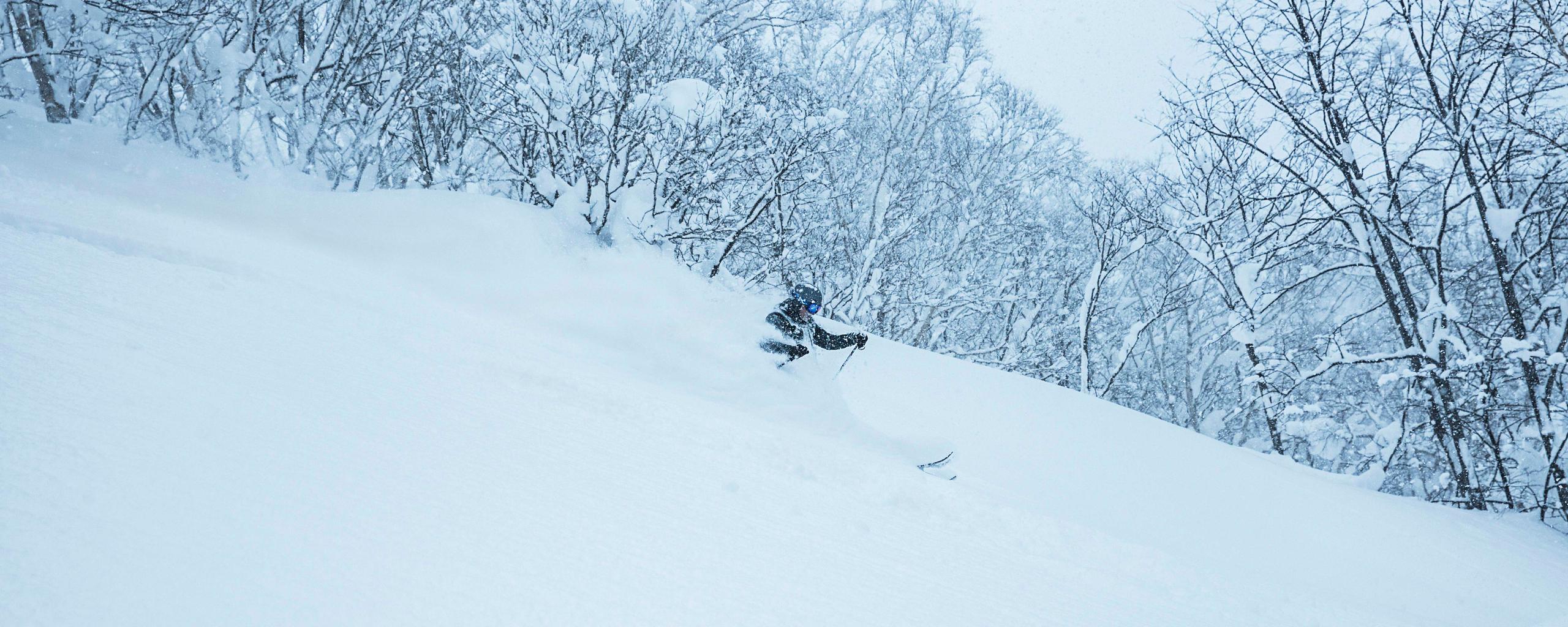 Man skiing in deep snow in Hokkaido Japan