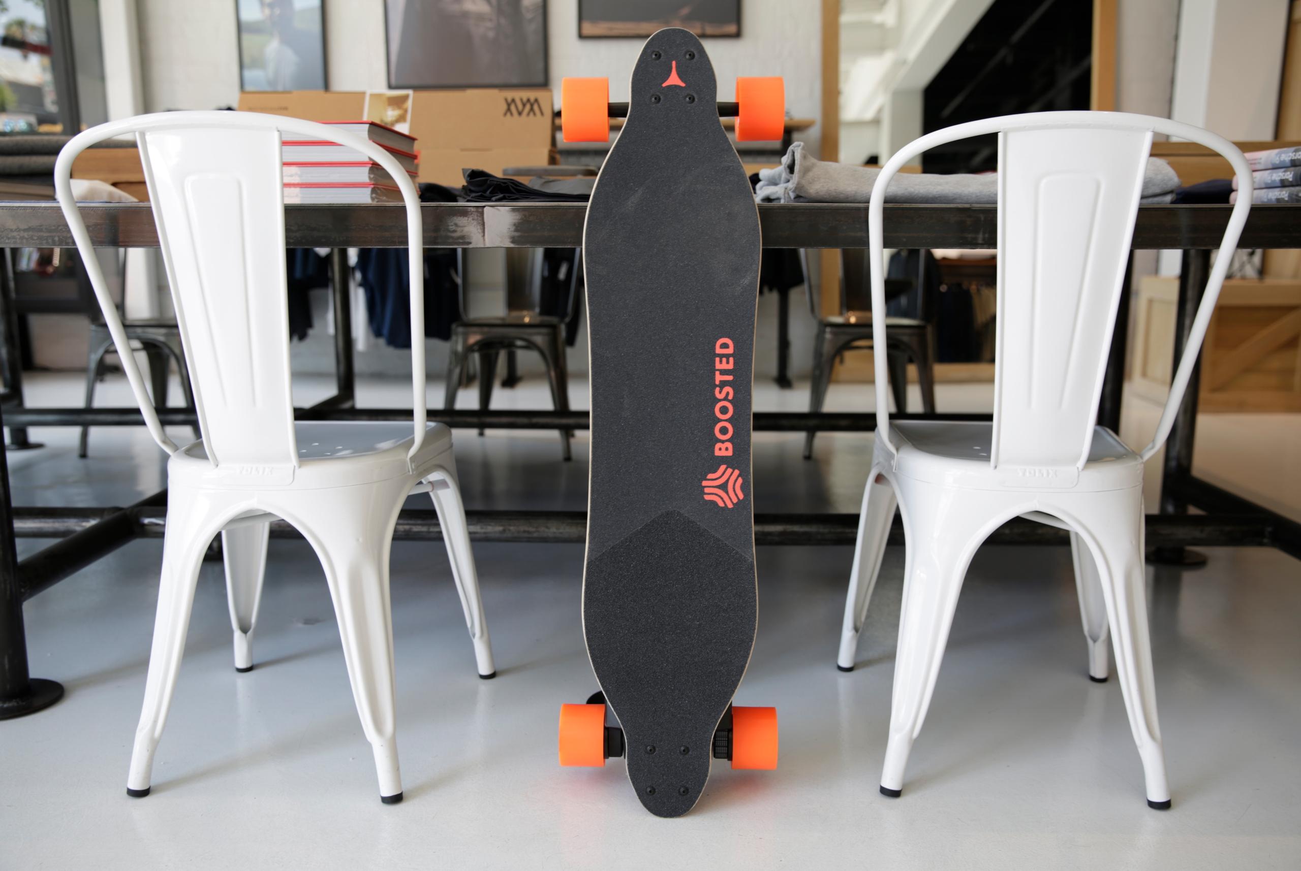 white dining chairs and skateboard leaning on dining table