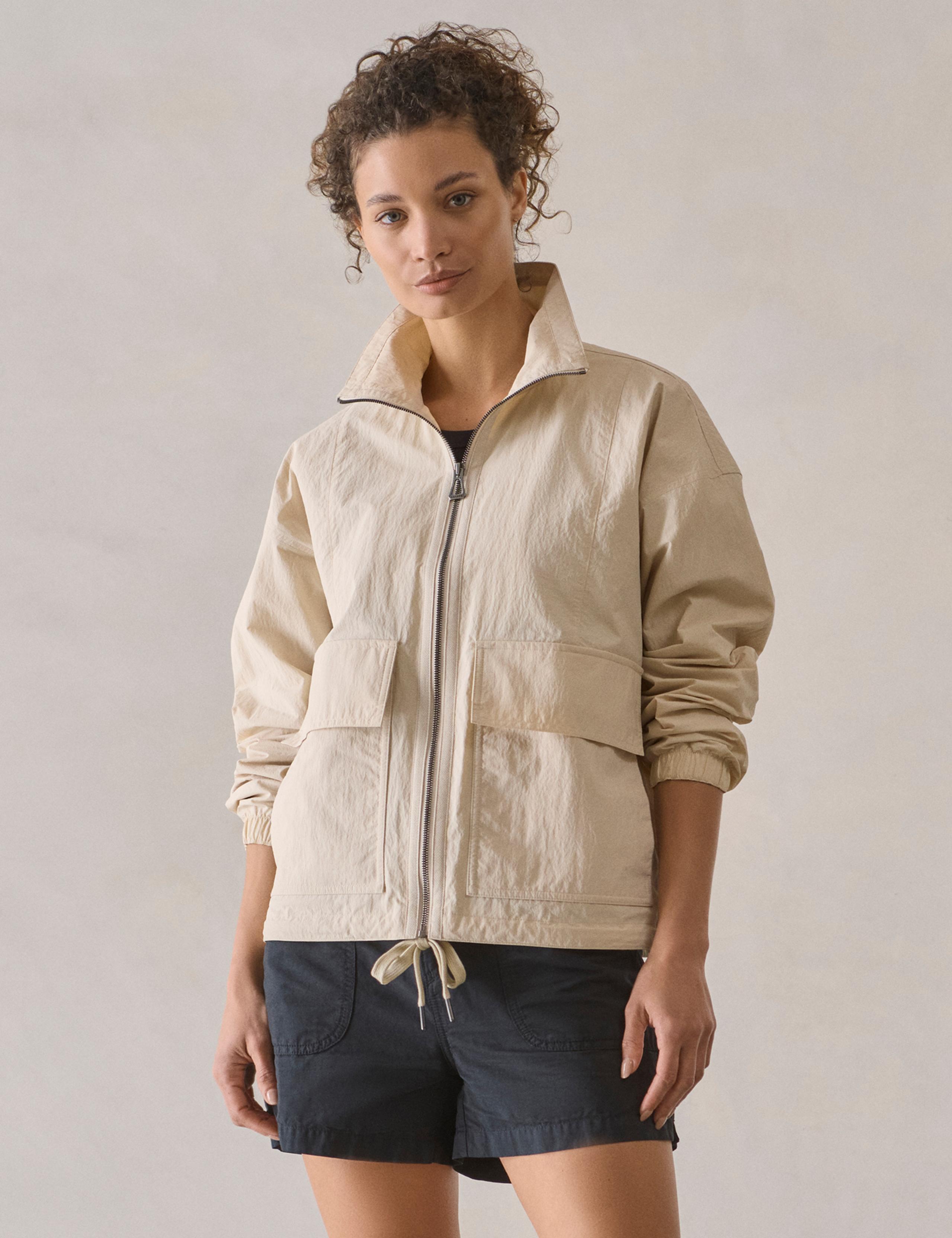 Woman in studio wearing the Mila Windbreaker