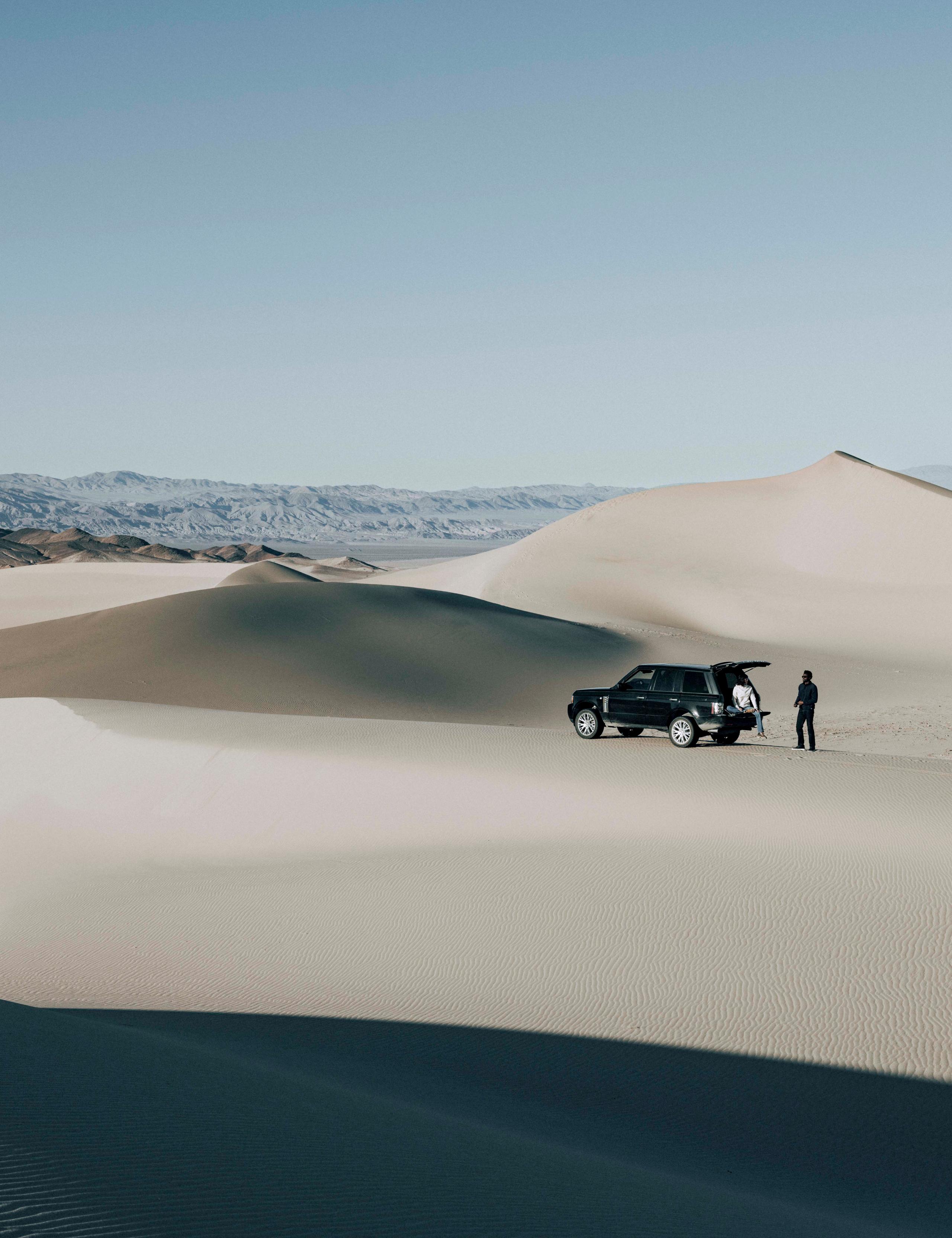 A SUV on sand dunes