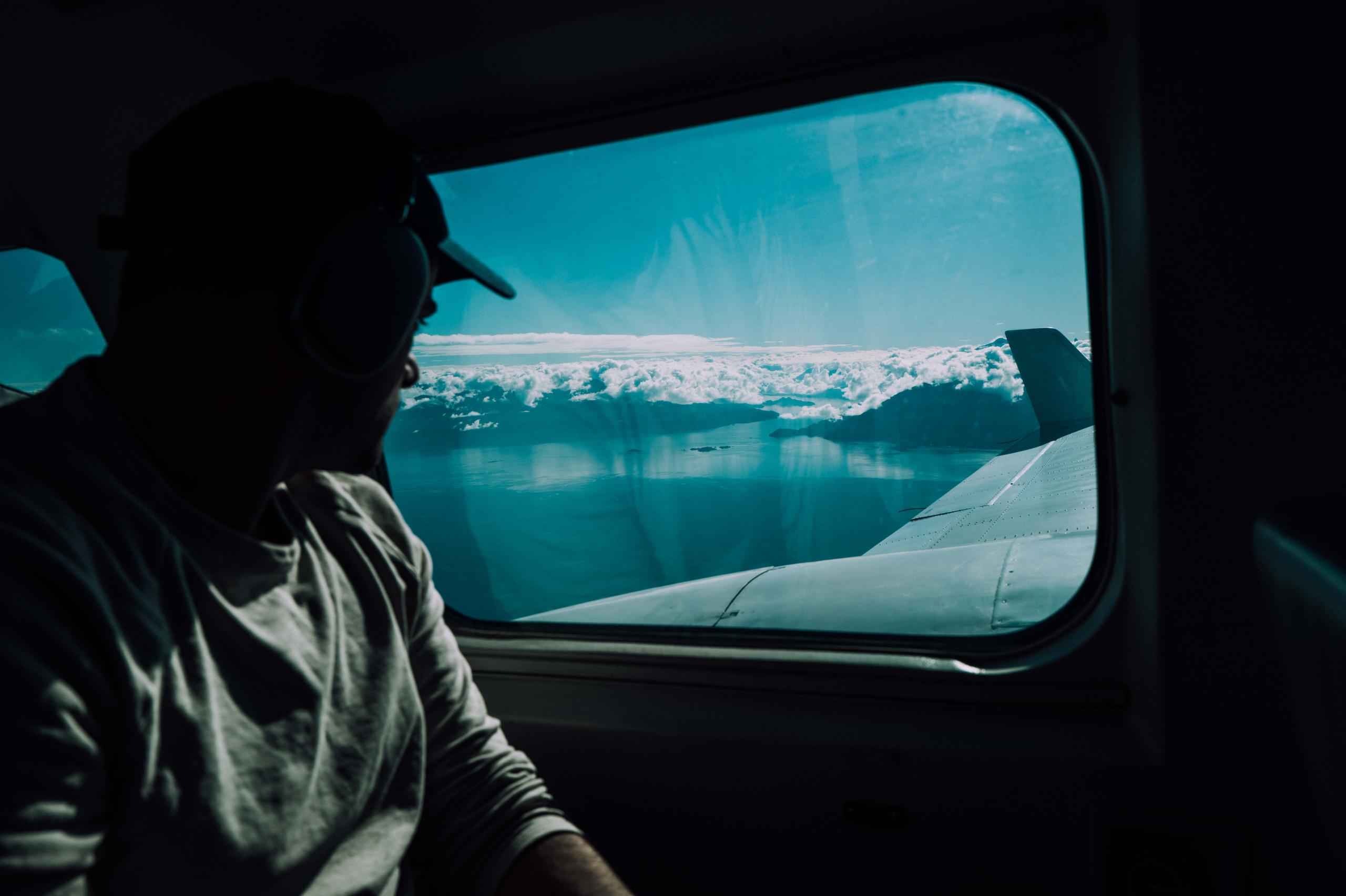 Man in plane overlooking Patagonia landscape and lake