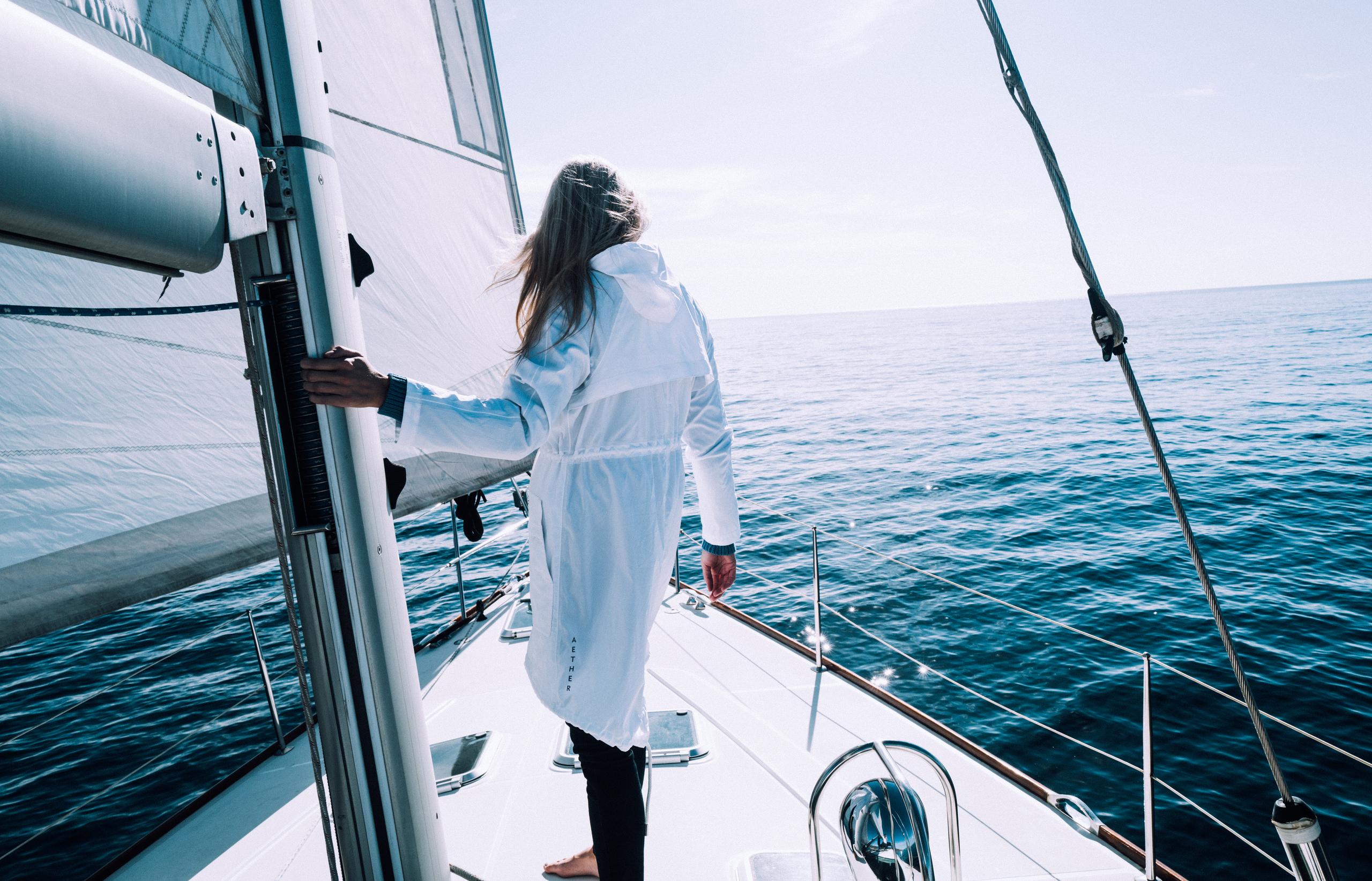Woman wearing Halley Jacket on a sailboat in the Pacific Ocean