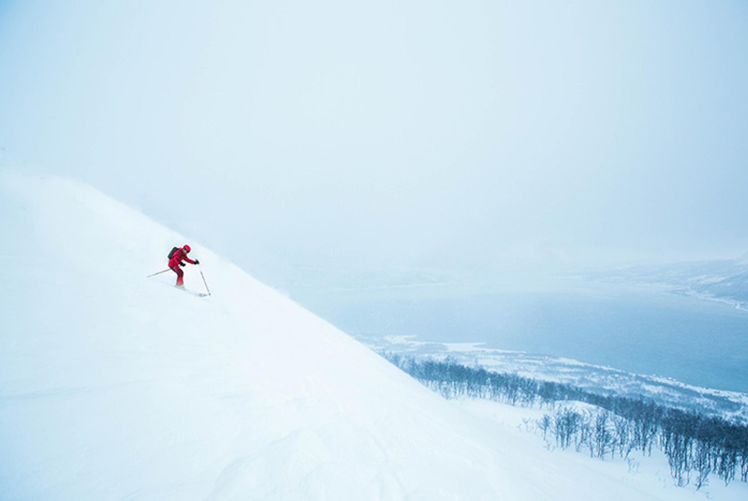 man skiing down mountain