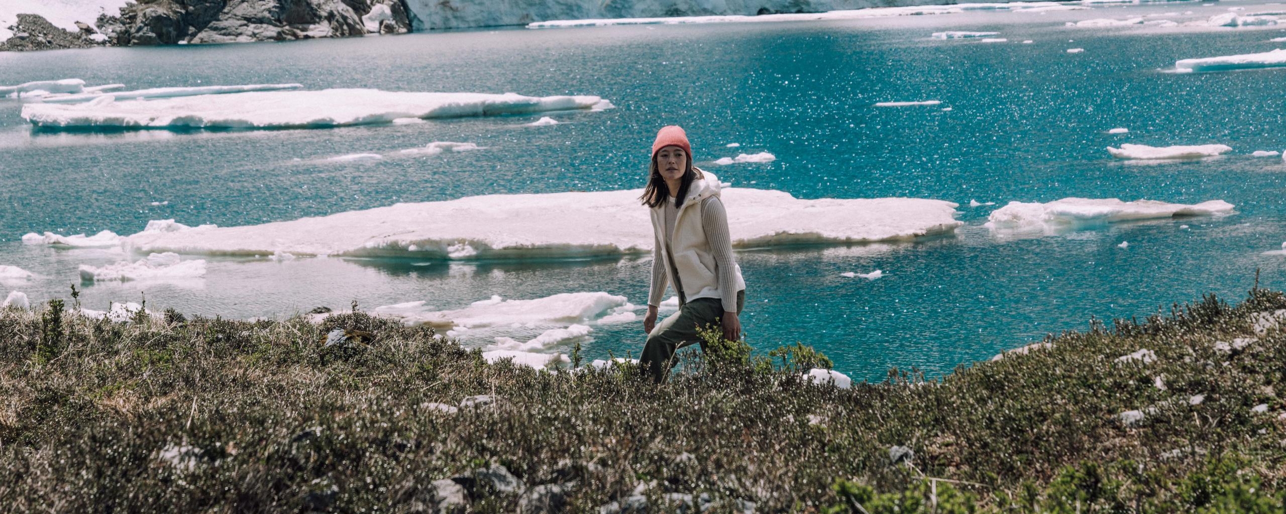Woman walking along icy lake in Patagonia