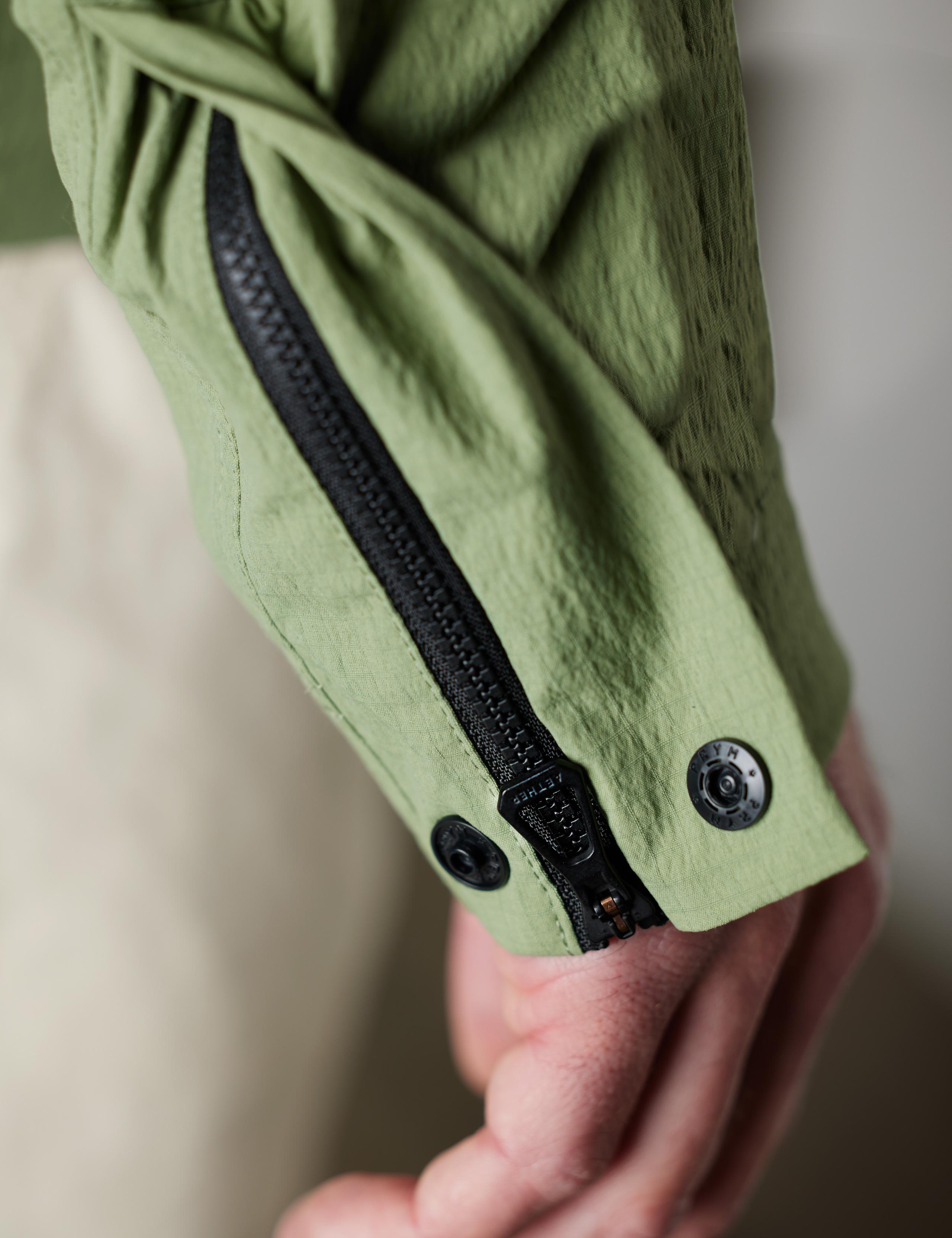 Studio closeup of zipper snap sleeve detail