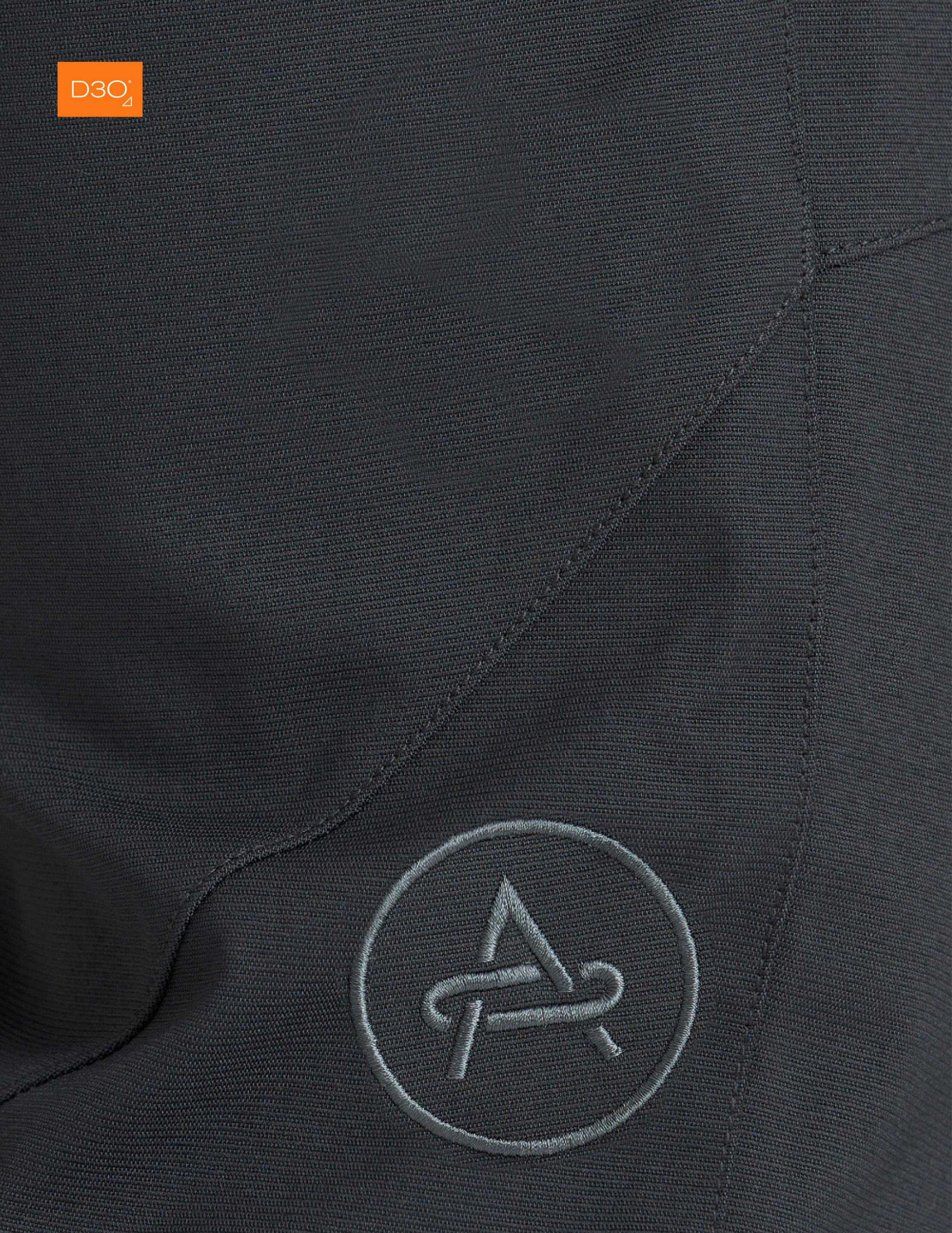 Closeup view of pant fabric with embroidered AETHER logo