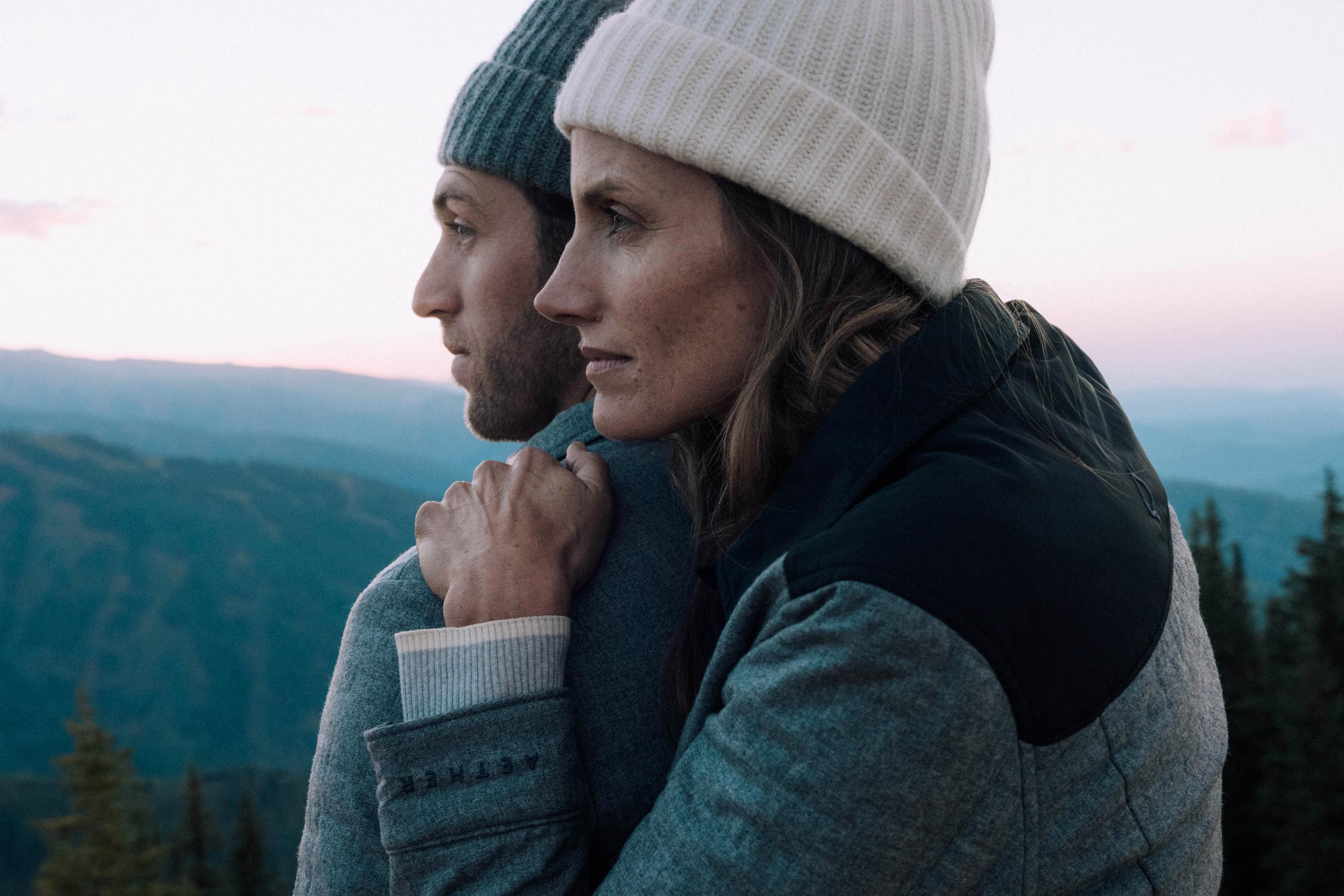 Profile of woman leaning on man's shoulder in front of Aspen mountains