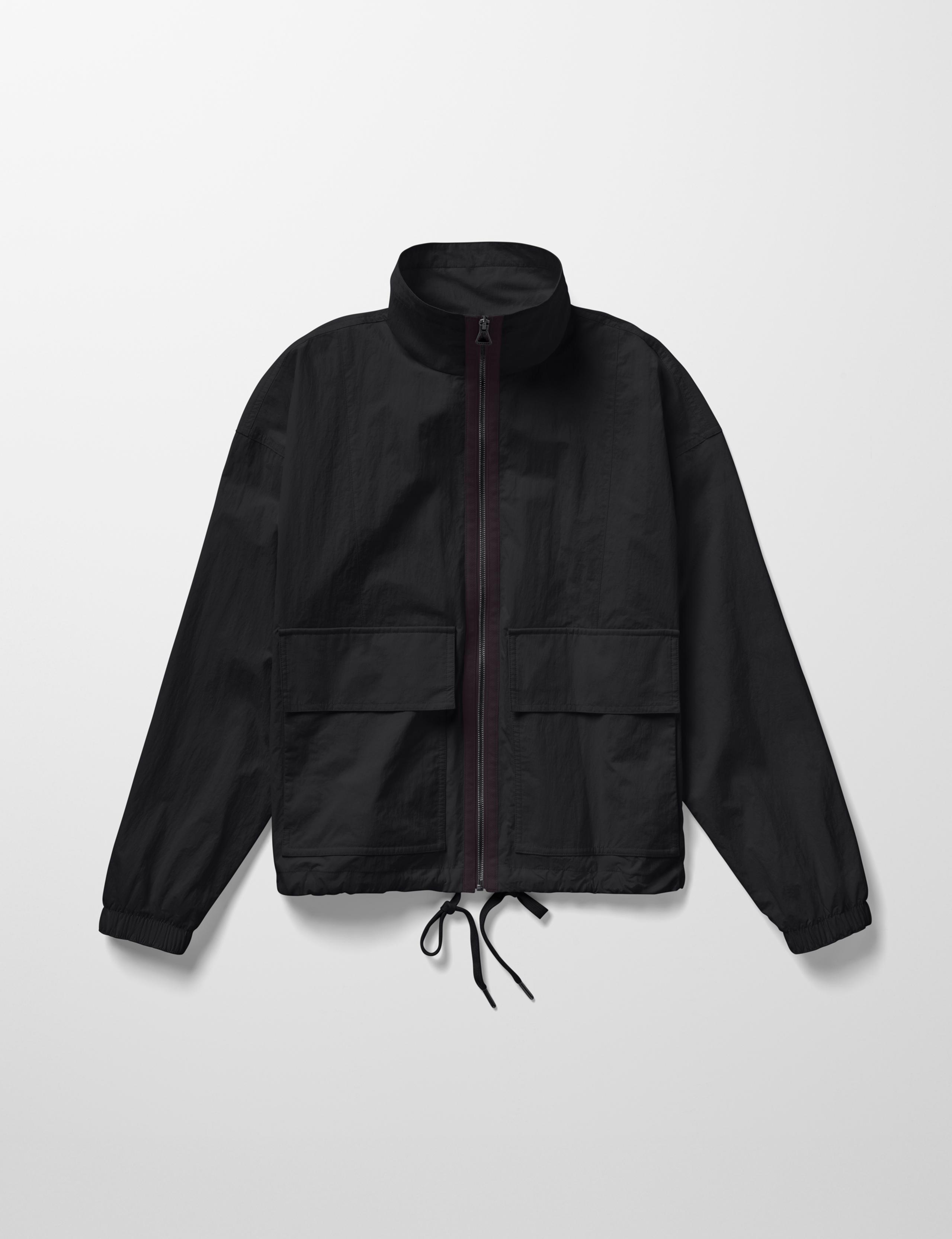 Studio laydown of Mila Windbreak in Onyx Black