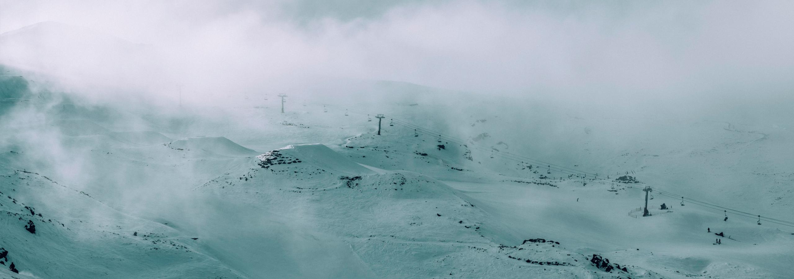 Foggy mountainside of ski runs in New Zealand