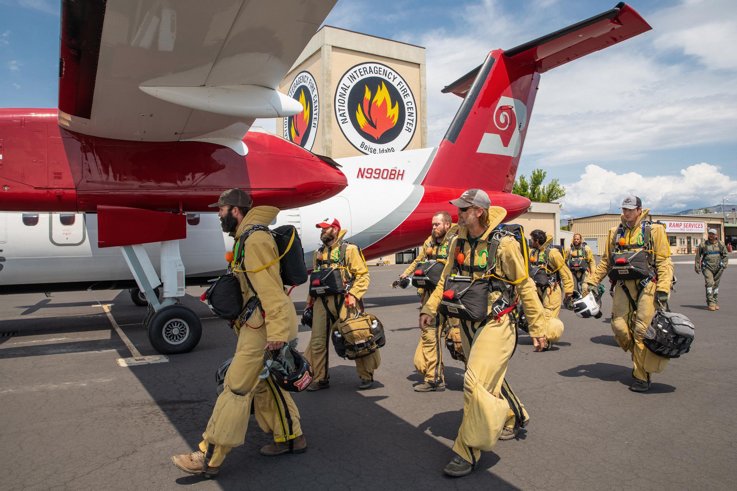 Group of Smokejumpers walking towards airplane