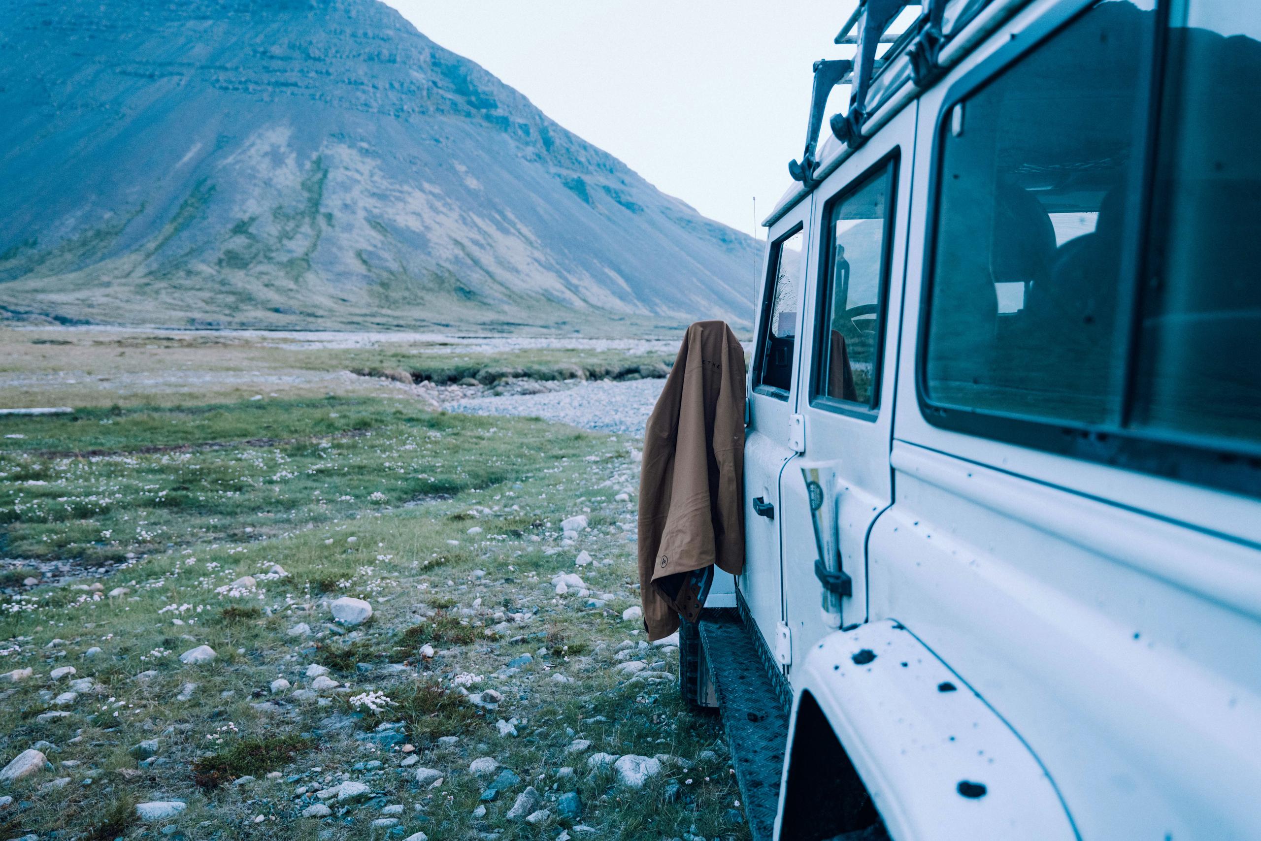 Jacket hanging on exterior mirror of Defender in Iceland landscape