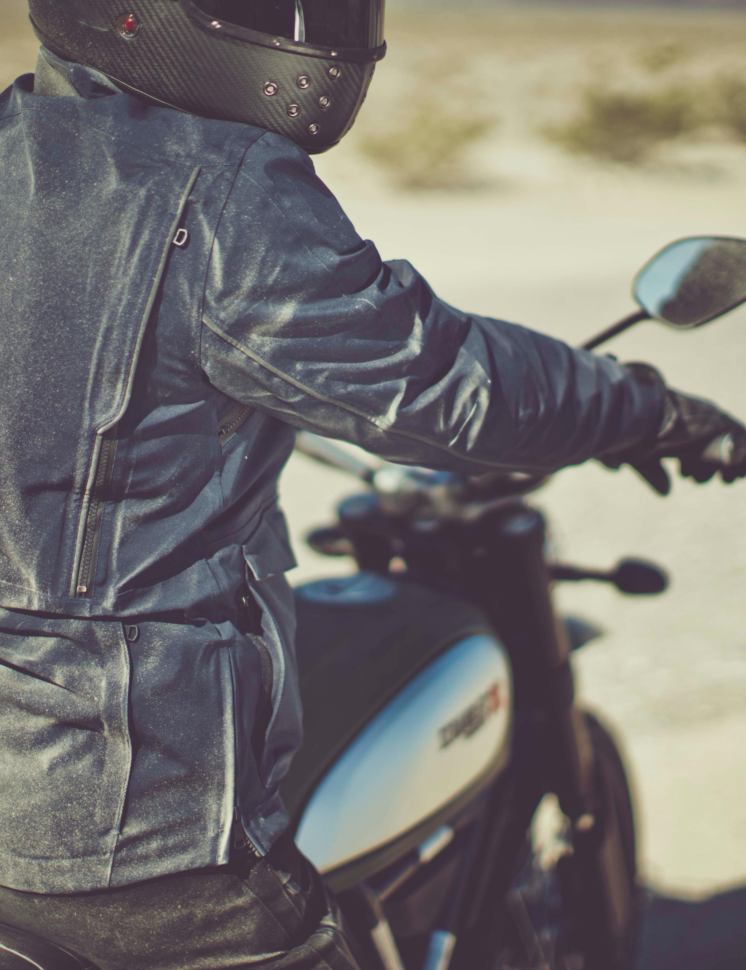 Man wearing a dusty Navigator Motorcycle Jacket