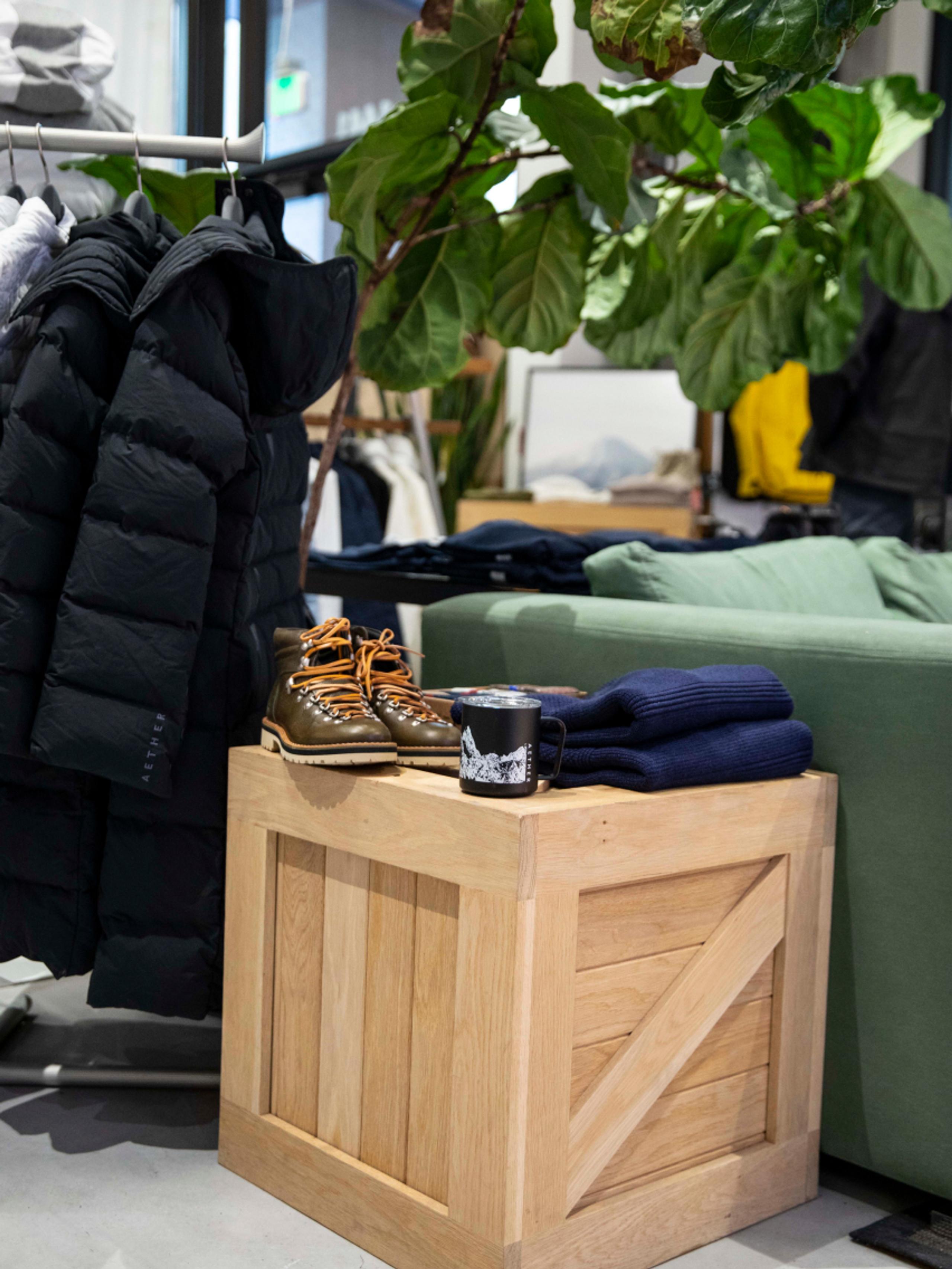 View inside AETHER Denver store of wood crate side table with product on top
