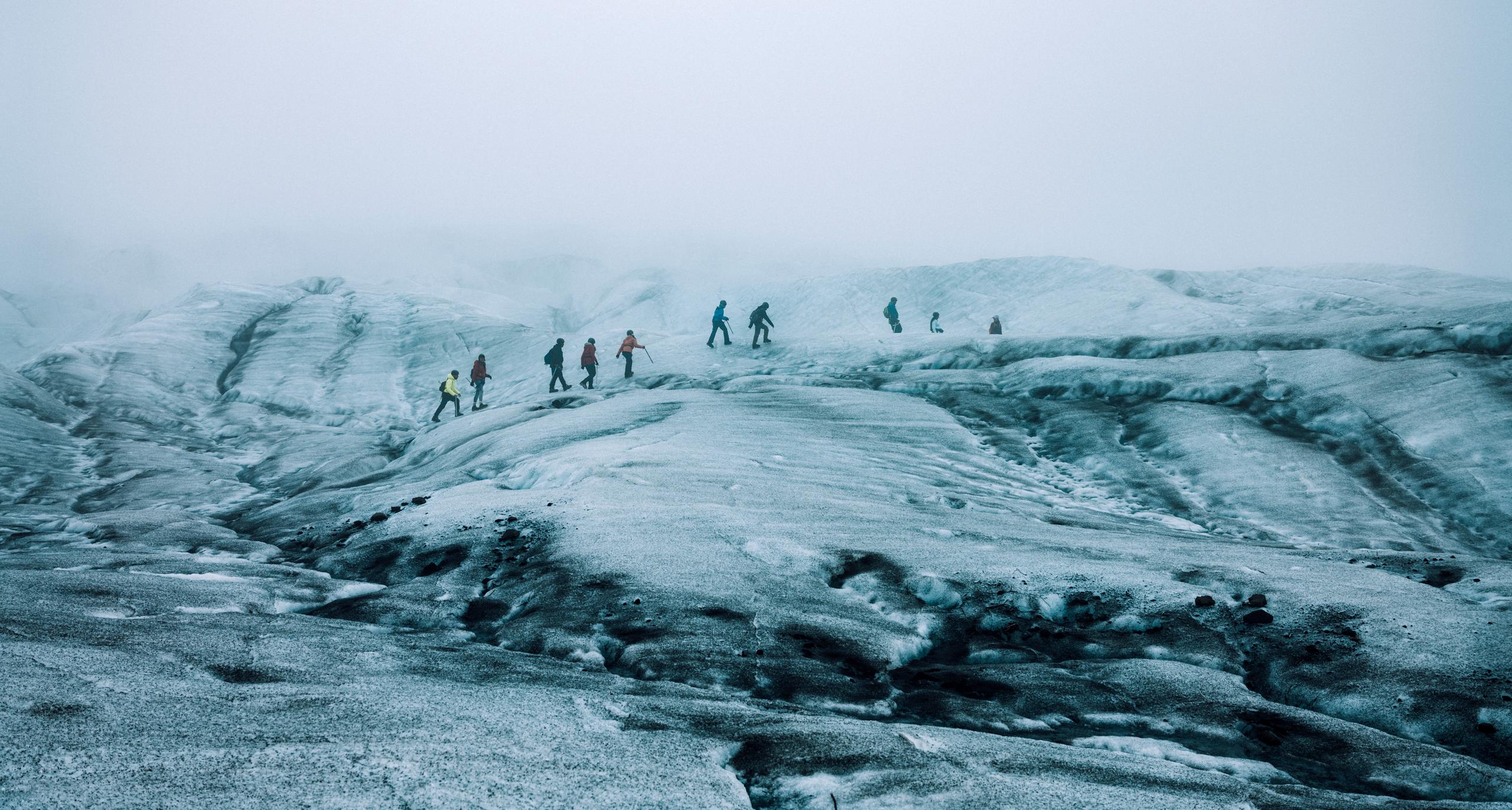 People hiking on glacier in Iceland.