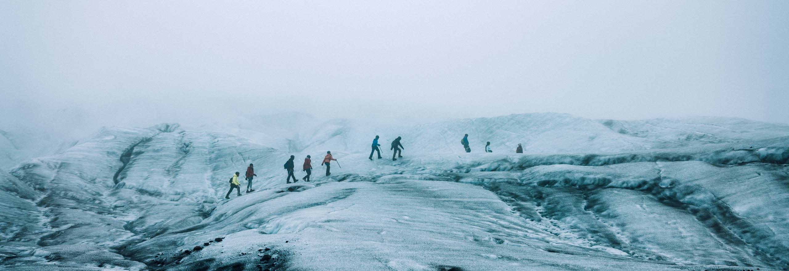 Group of people hiking across glacier in Iceland
