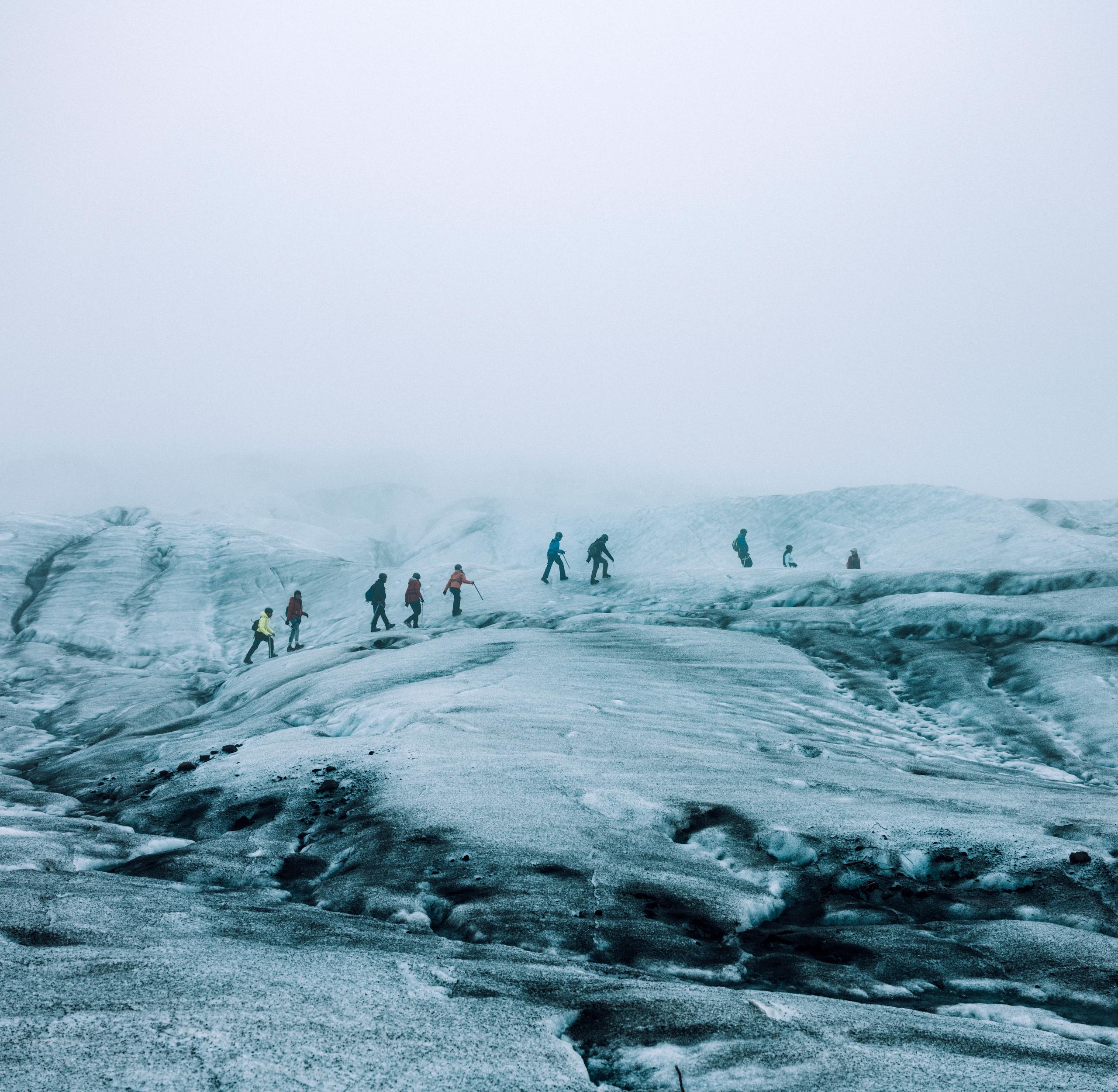 Group of people hiking across glacier in Iceland