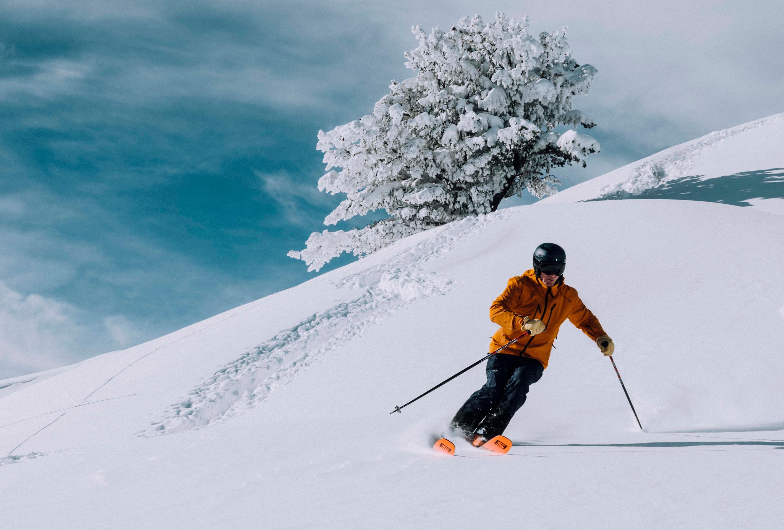 Man skiing down snowy mountain in Park City, Utah