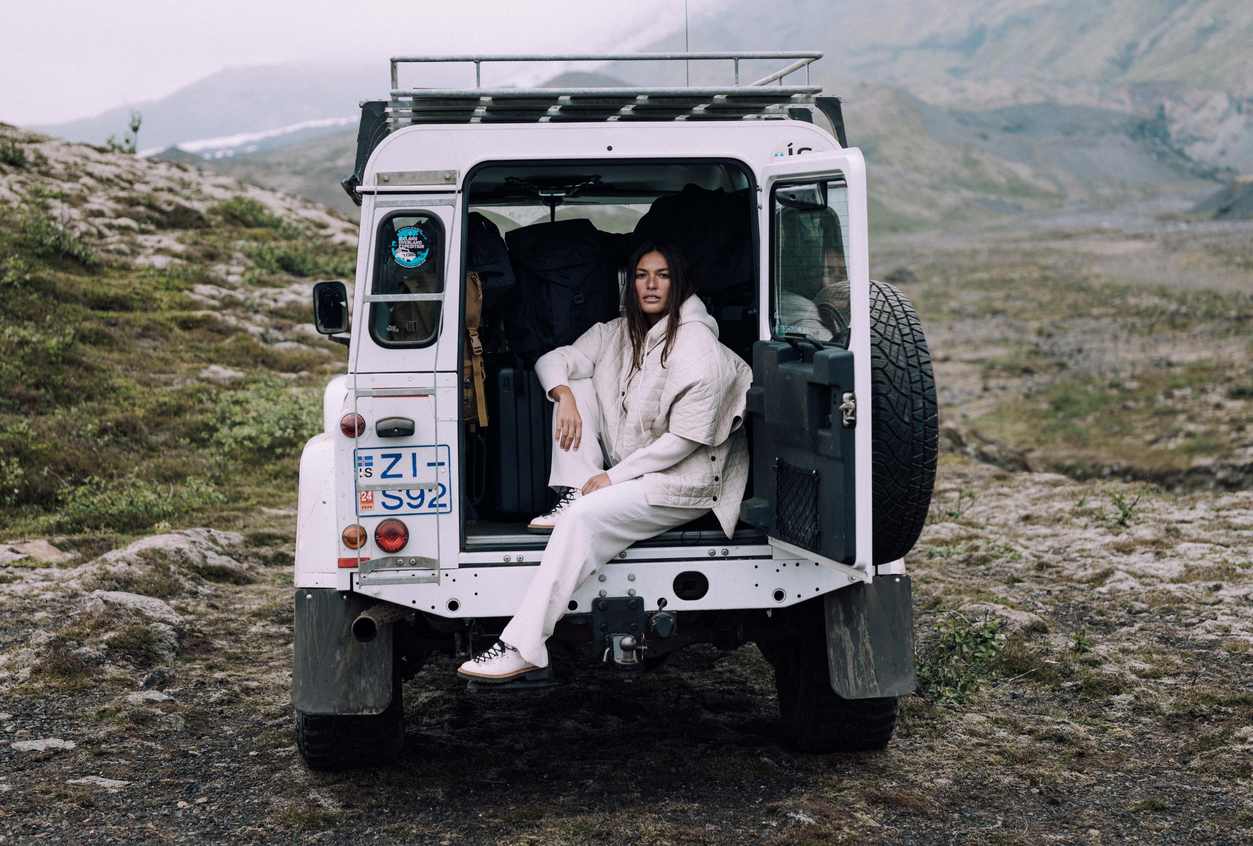 A girl in Bardo Poncho Jacket sitting in an SUV. 
