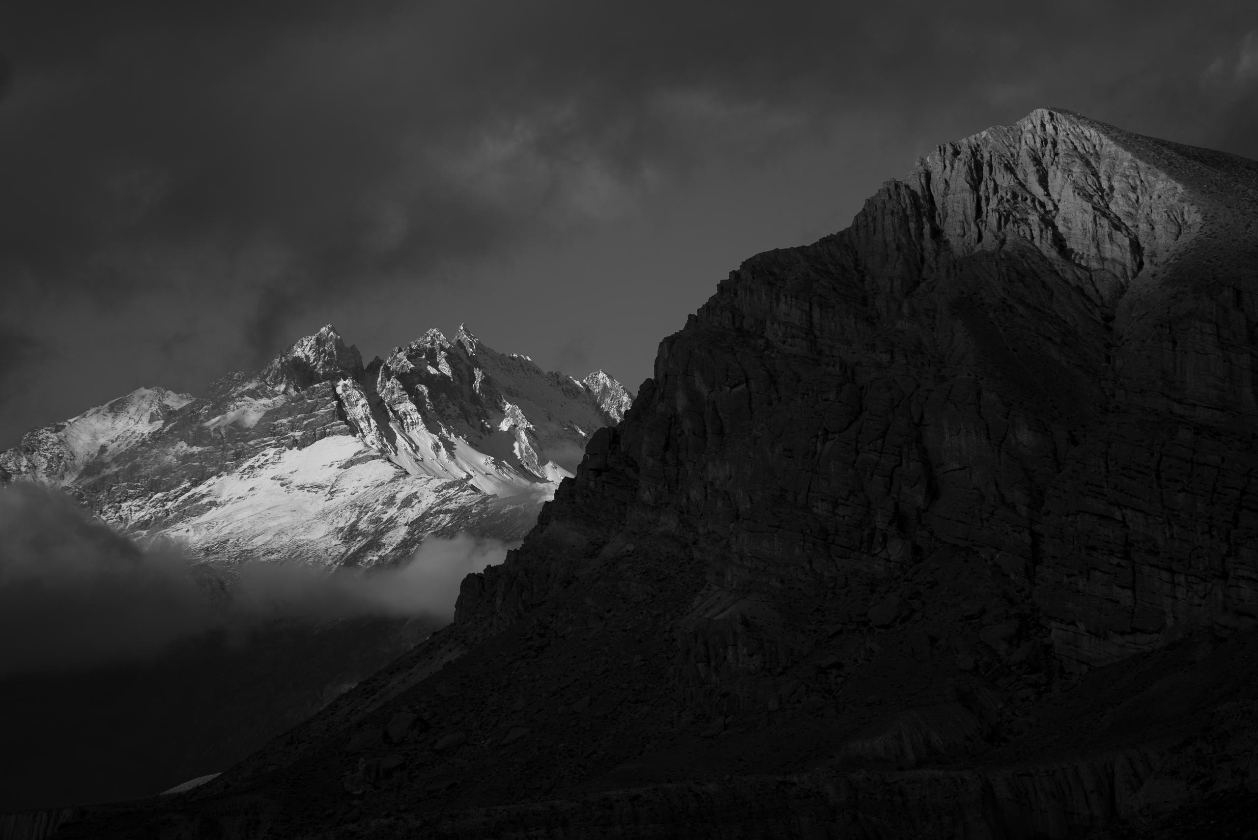 Moody black and white photograph of Himalayan mountains