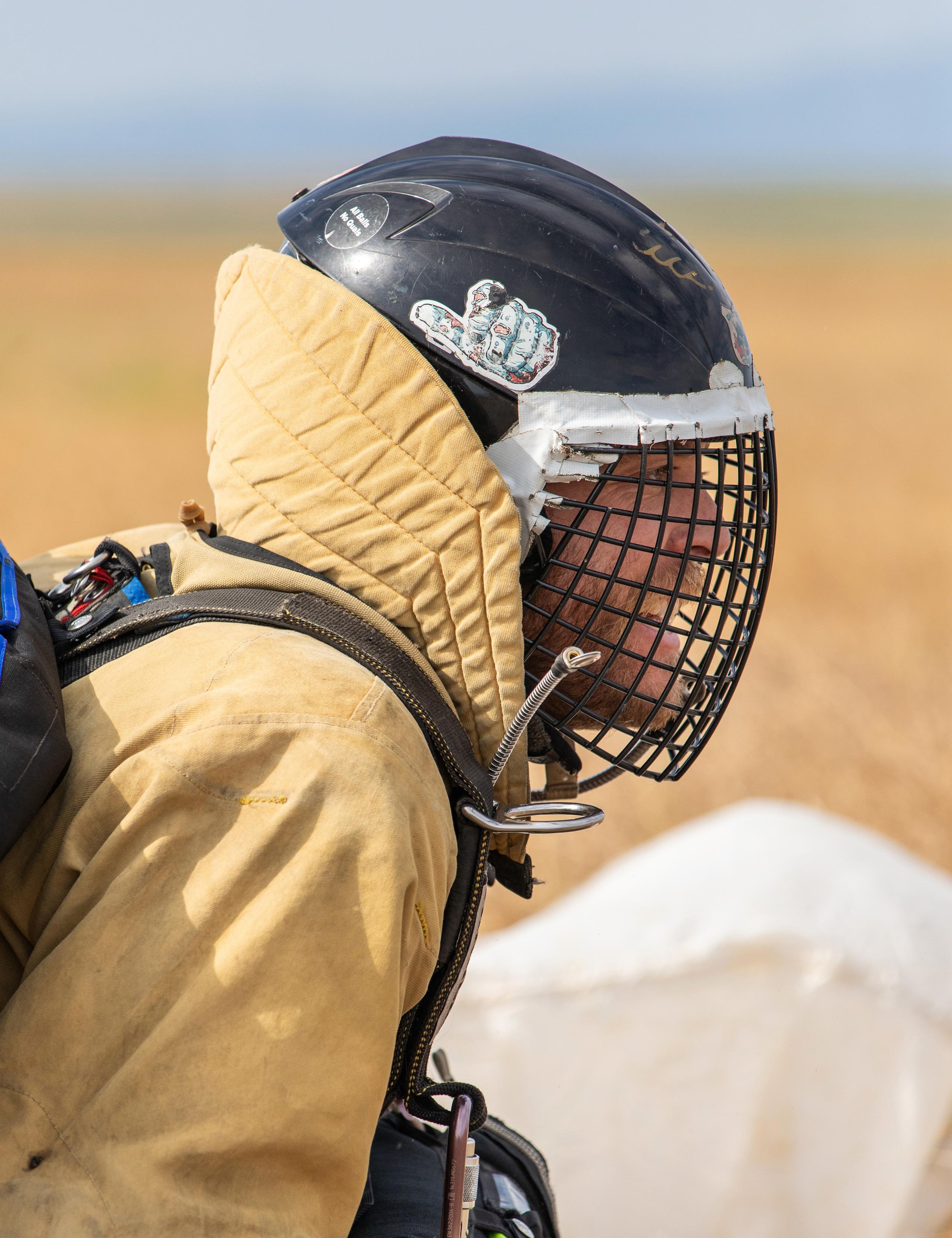 Profile portrait of smokejumper in full gear and caged helmet