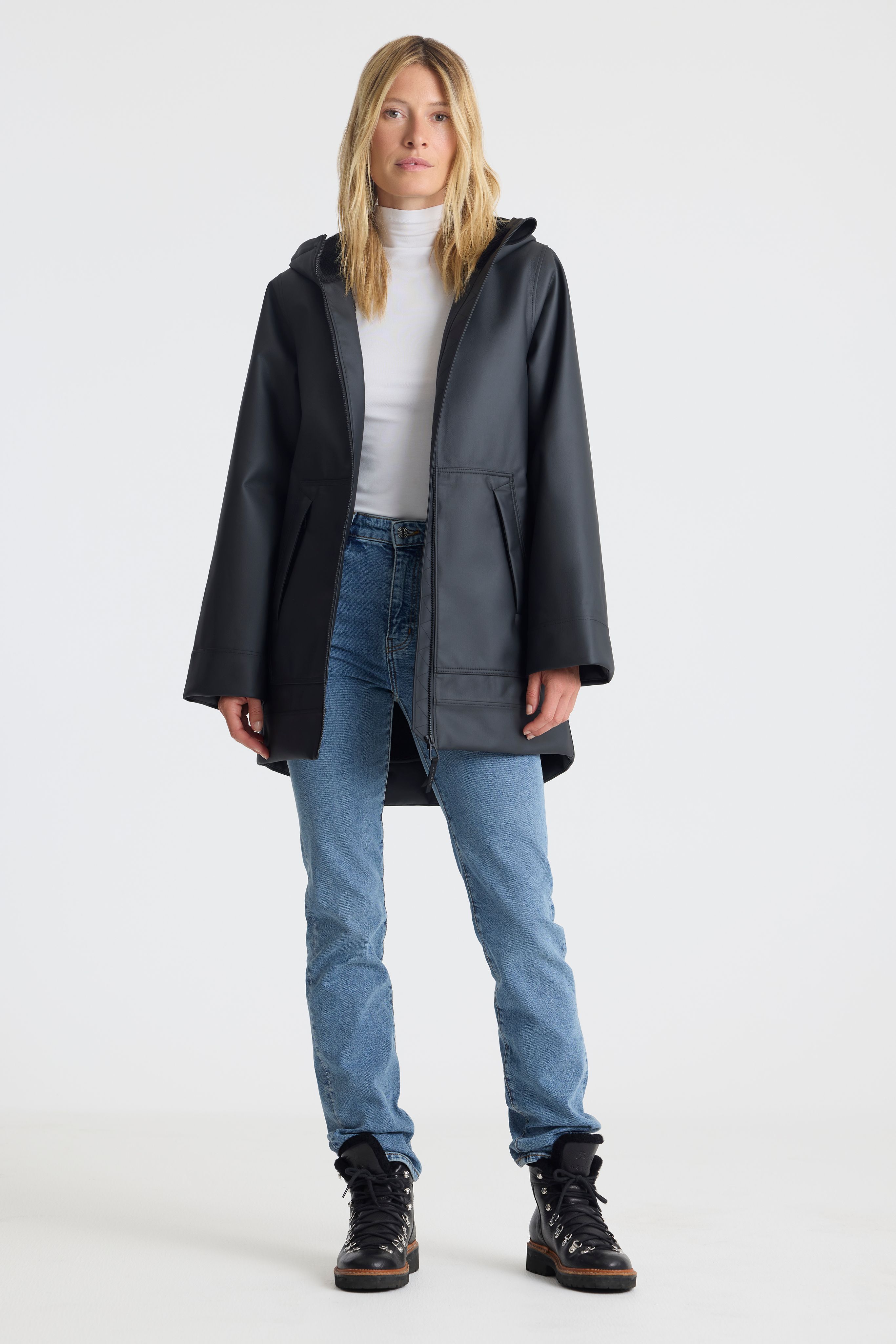 Woman wearing Quest Rain Jacket in studio