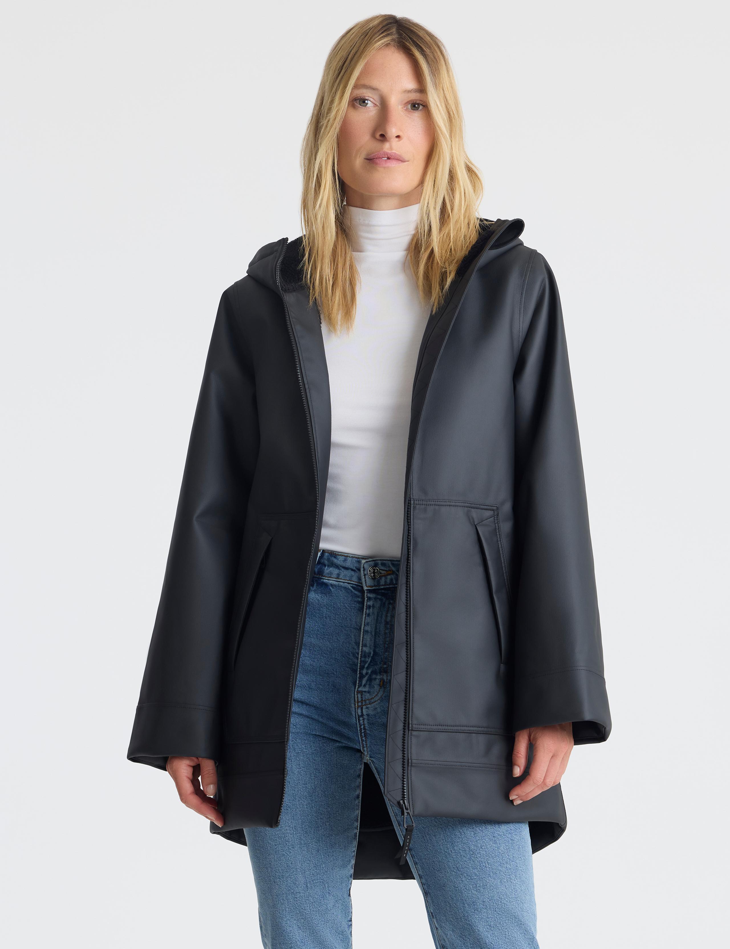 Woman wearing Quest Rain Jacket in studio