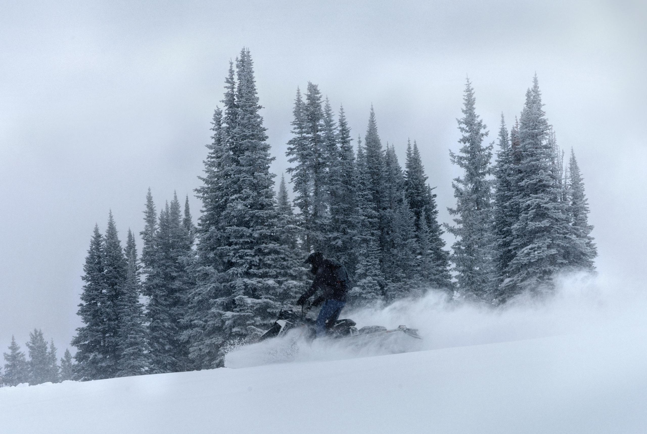 man riding snowmobile