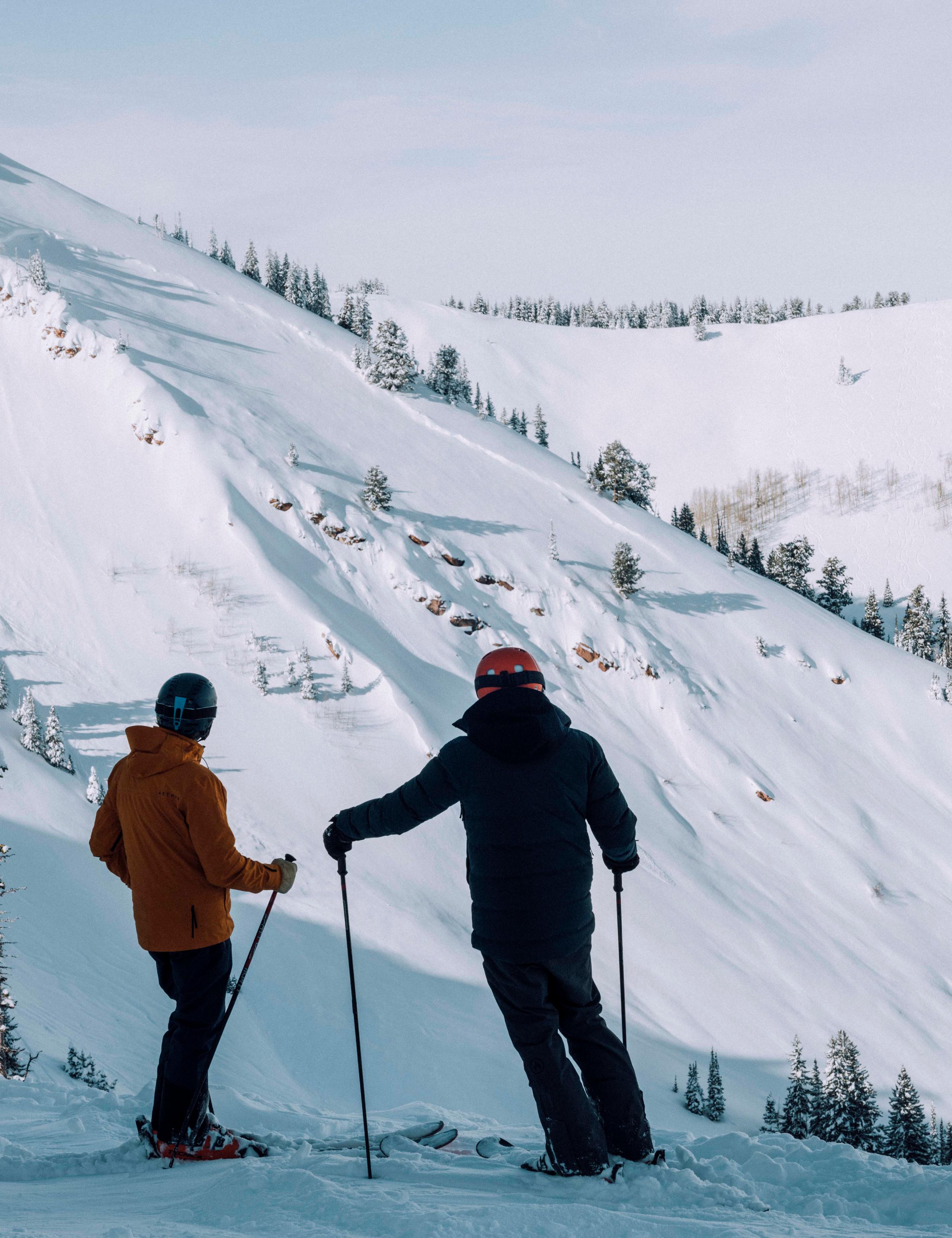 Two men in ski outfit on snow mountain.