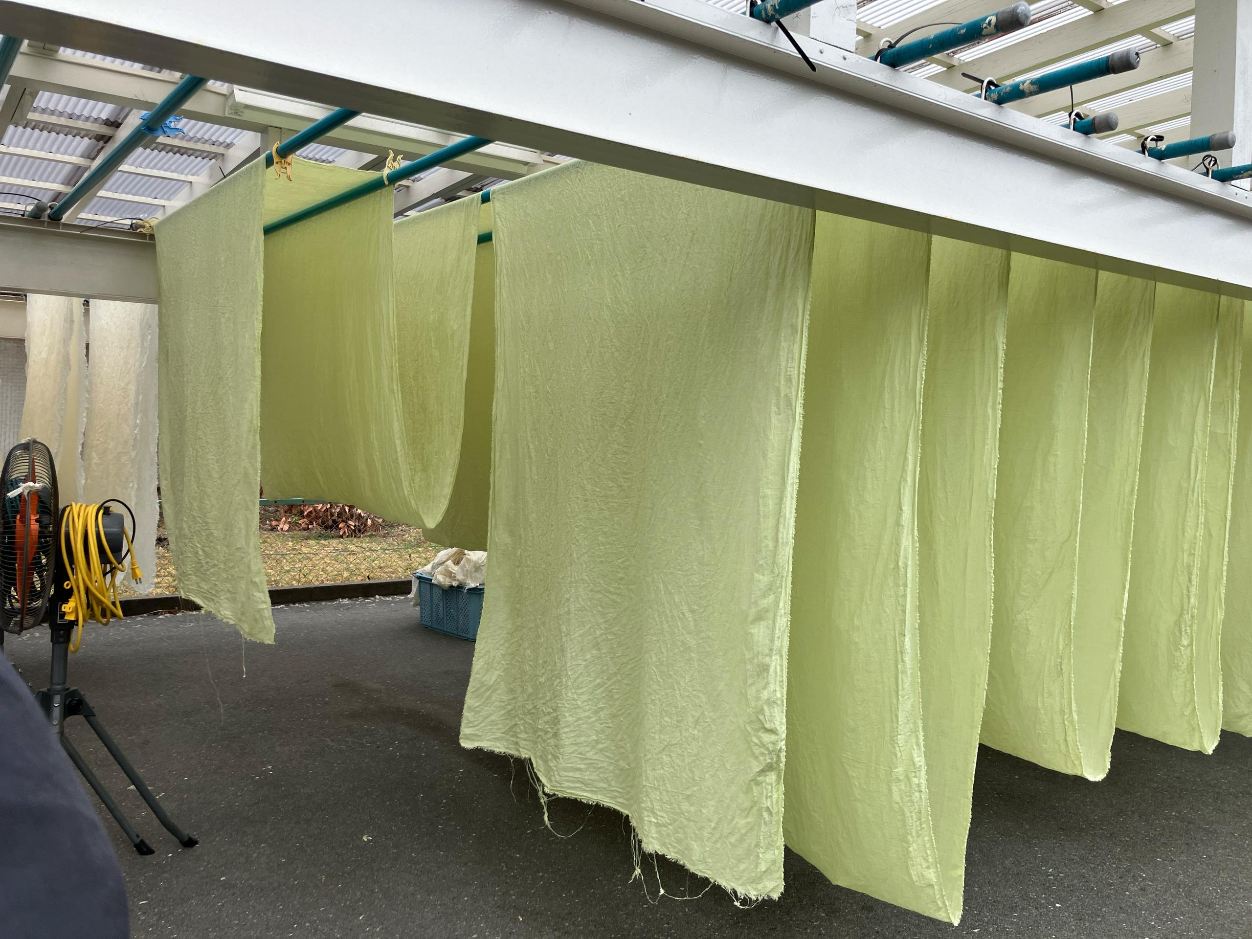 Hand dyed fabric line drying in Japan