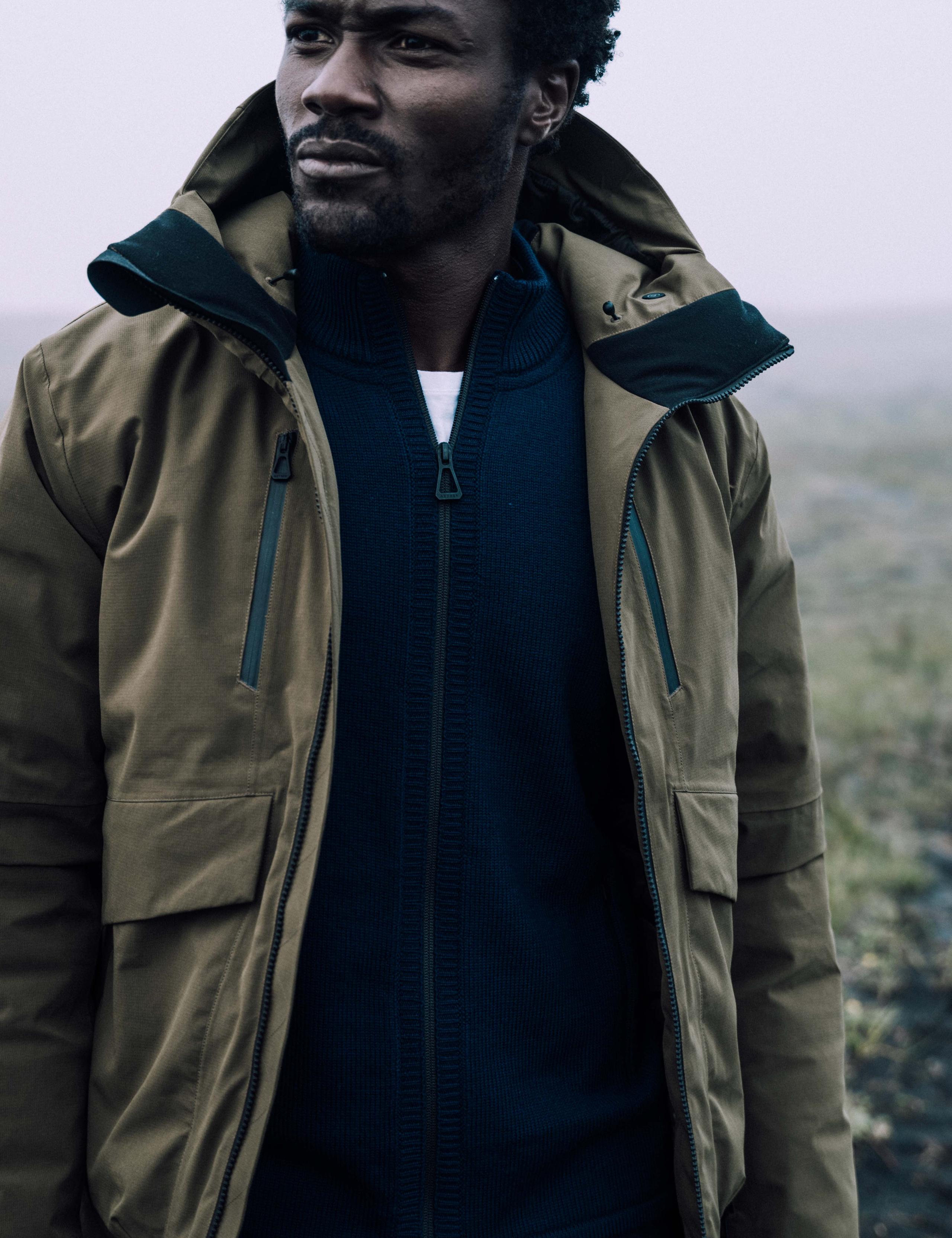 Remy layering the Riley Full-Zip inside a jacket.