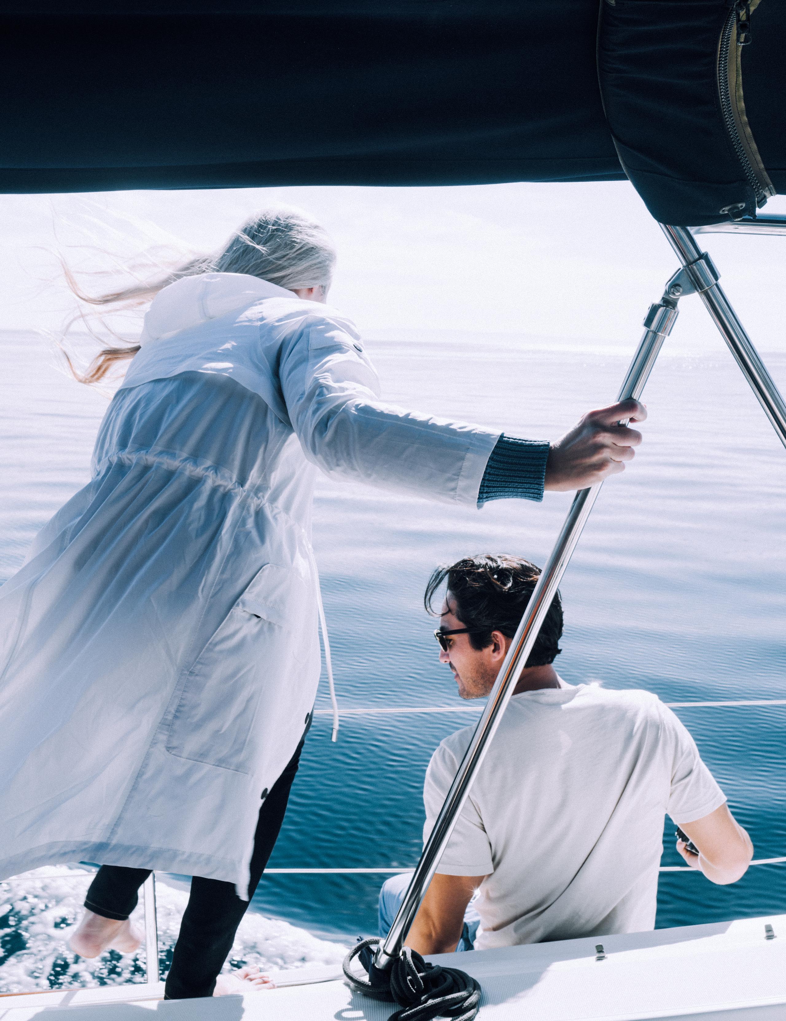 Woman wearing Halley Jacket next to man on sailboat on Pacific Ocean!
