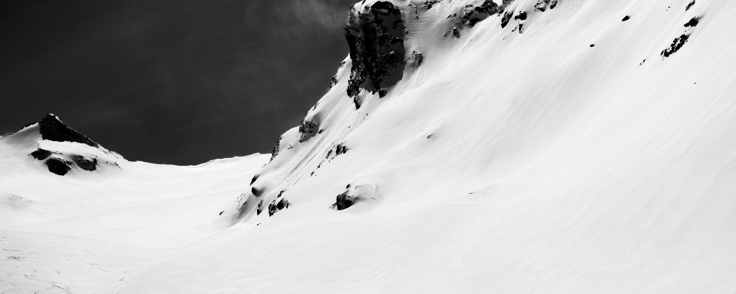 Black and white photo of snowy ridge.