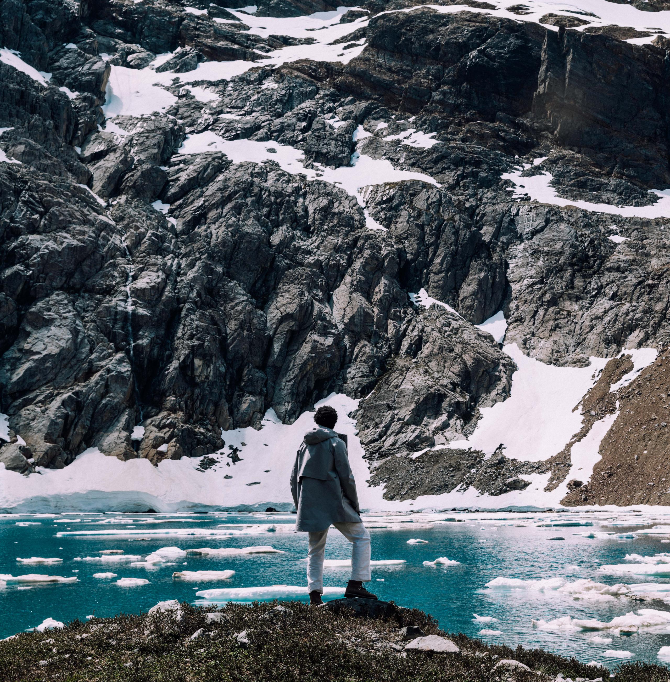 Man standing along edge of icy lake in the Patagonia region of Chile