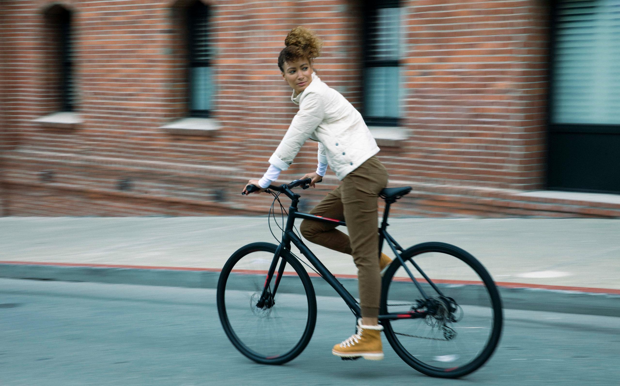 Women wearing Friday Pant on bicycle