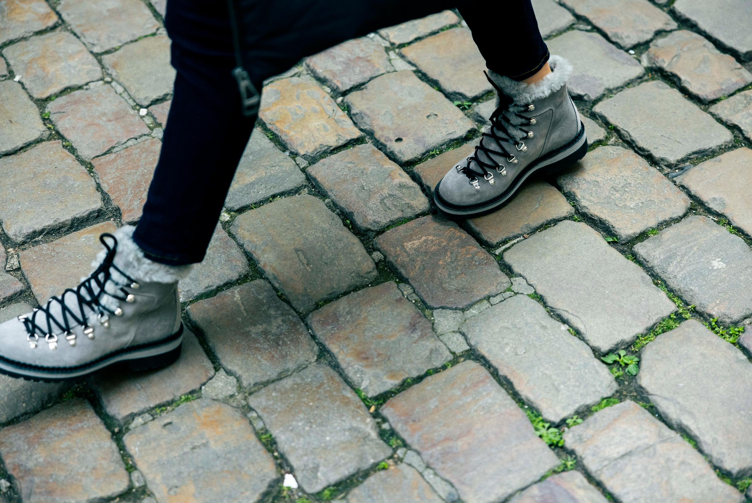Close up of woman walking with W Dolomite Boots on cobblestone street in Lyon, France