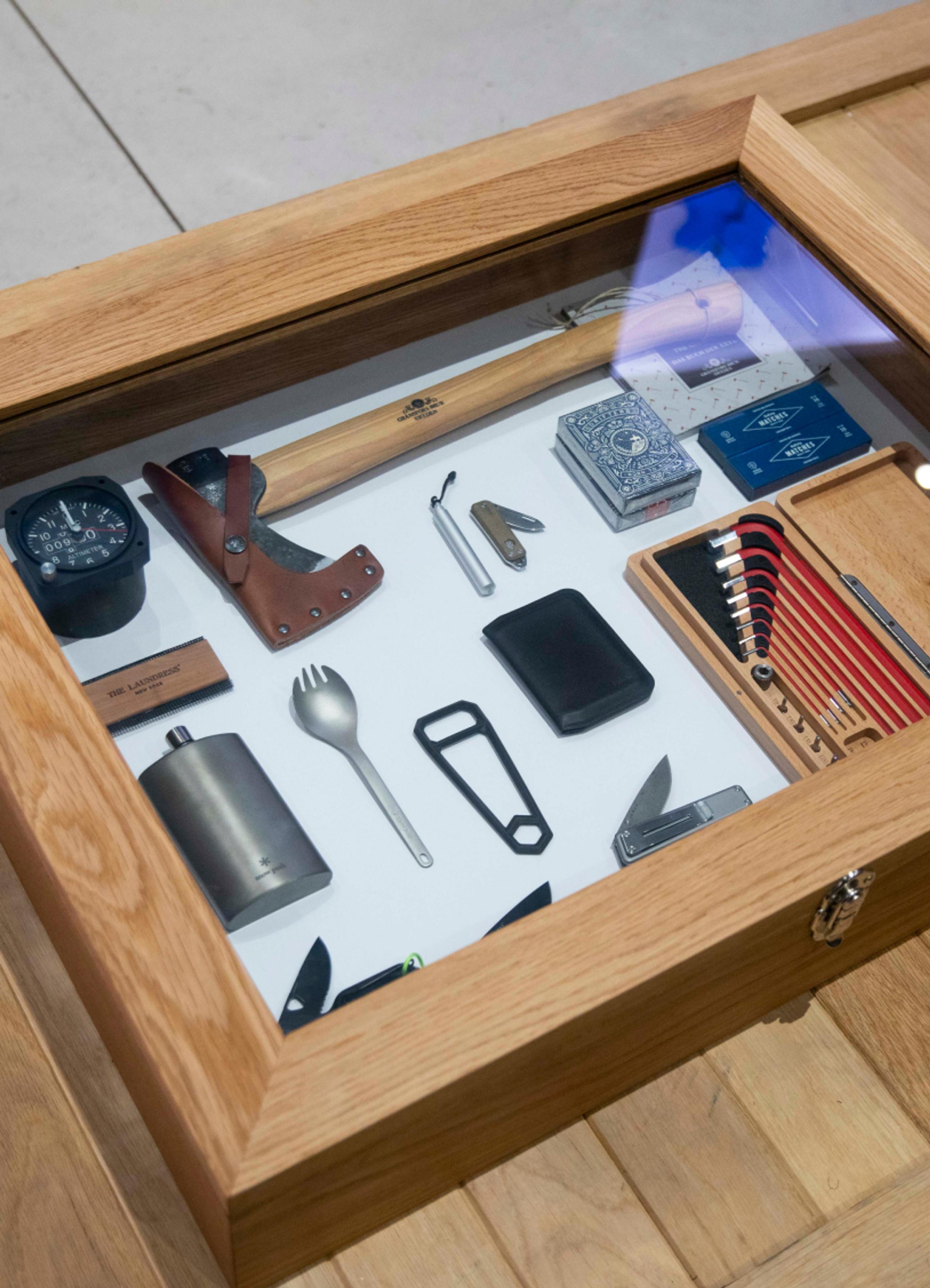 View of tabletop wood case with outdoor tools
