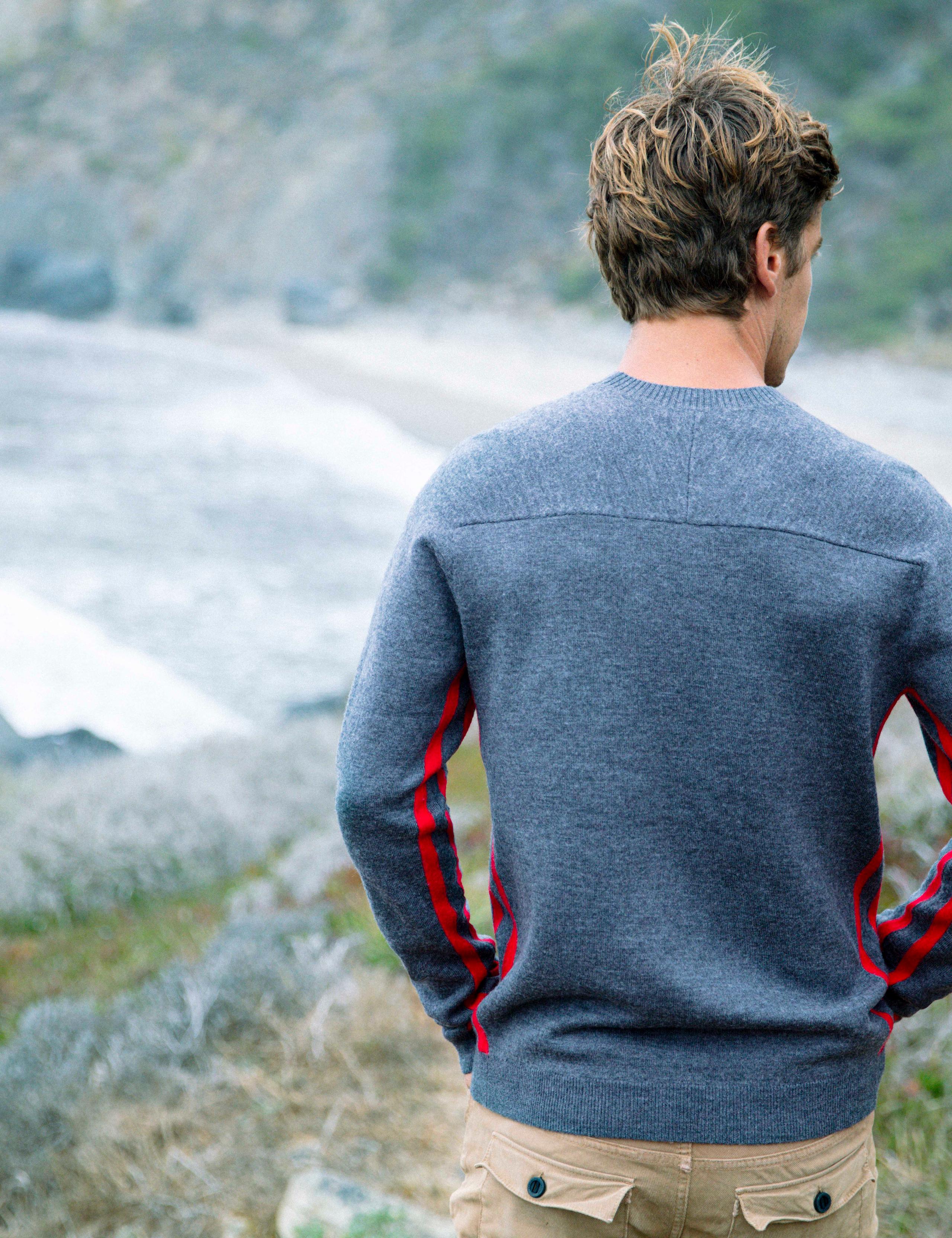Men wearing M Racer Sweater on coastal hill